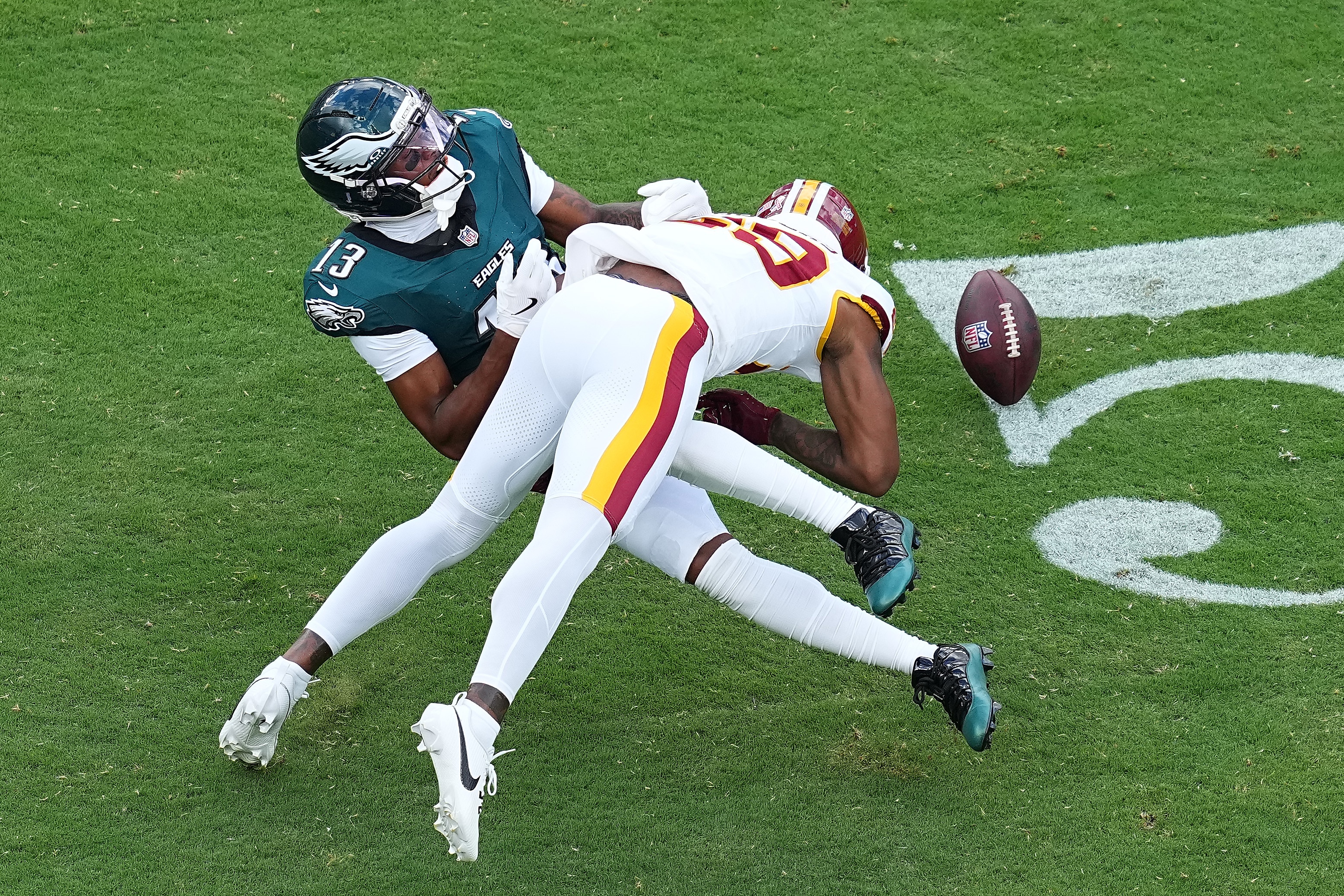 Darius Rush of the Commanders breaks up a pass intended for Dontayvion Wicks of the Eagles in the first quarter Sunday.