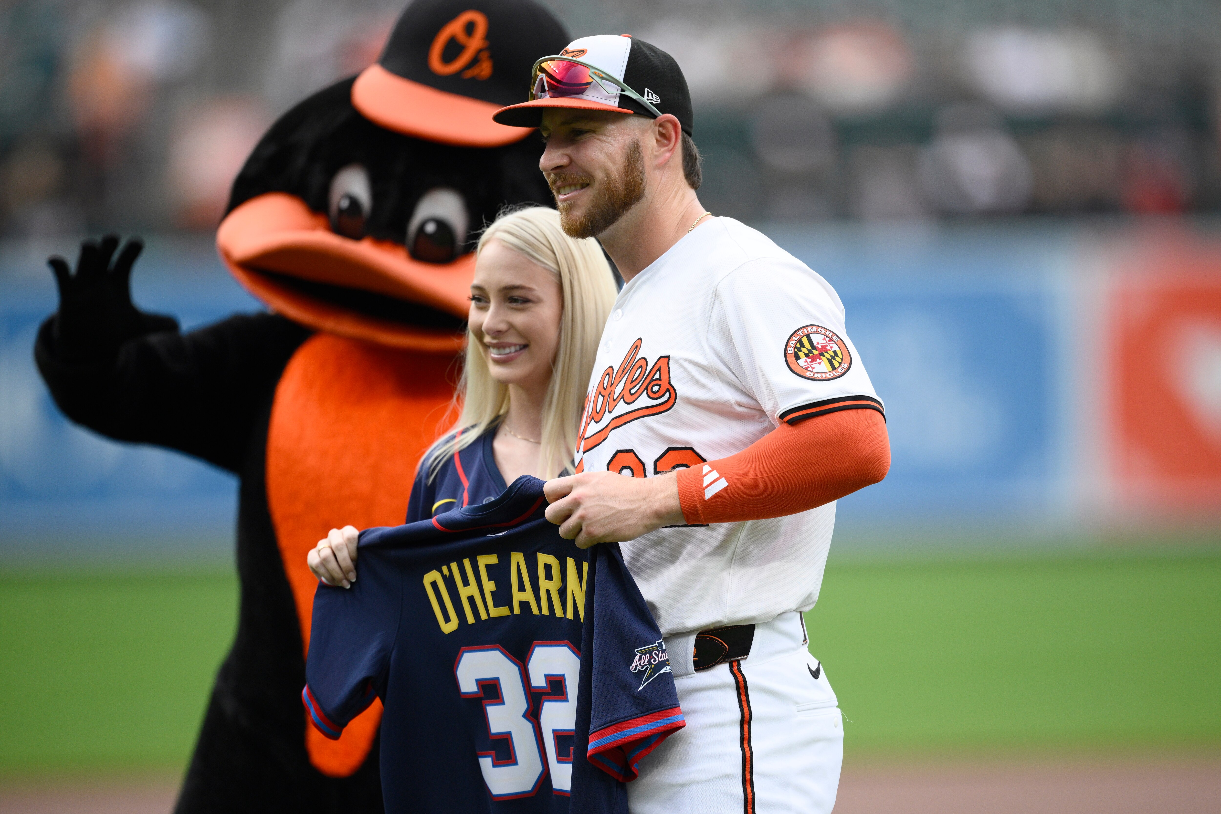 Baltimore Orioles' Ryan O'Hearn, right, poses with his wife Hannah as he is recognized for being an All-Star before a baseball game against the Miami Marlins, Sunday, July 13, 2025, in Baltimore.