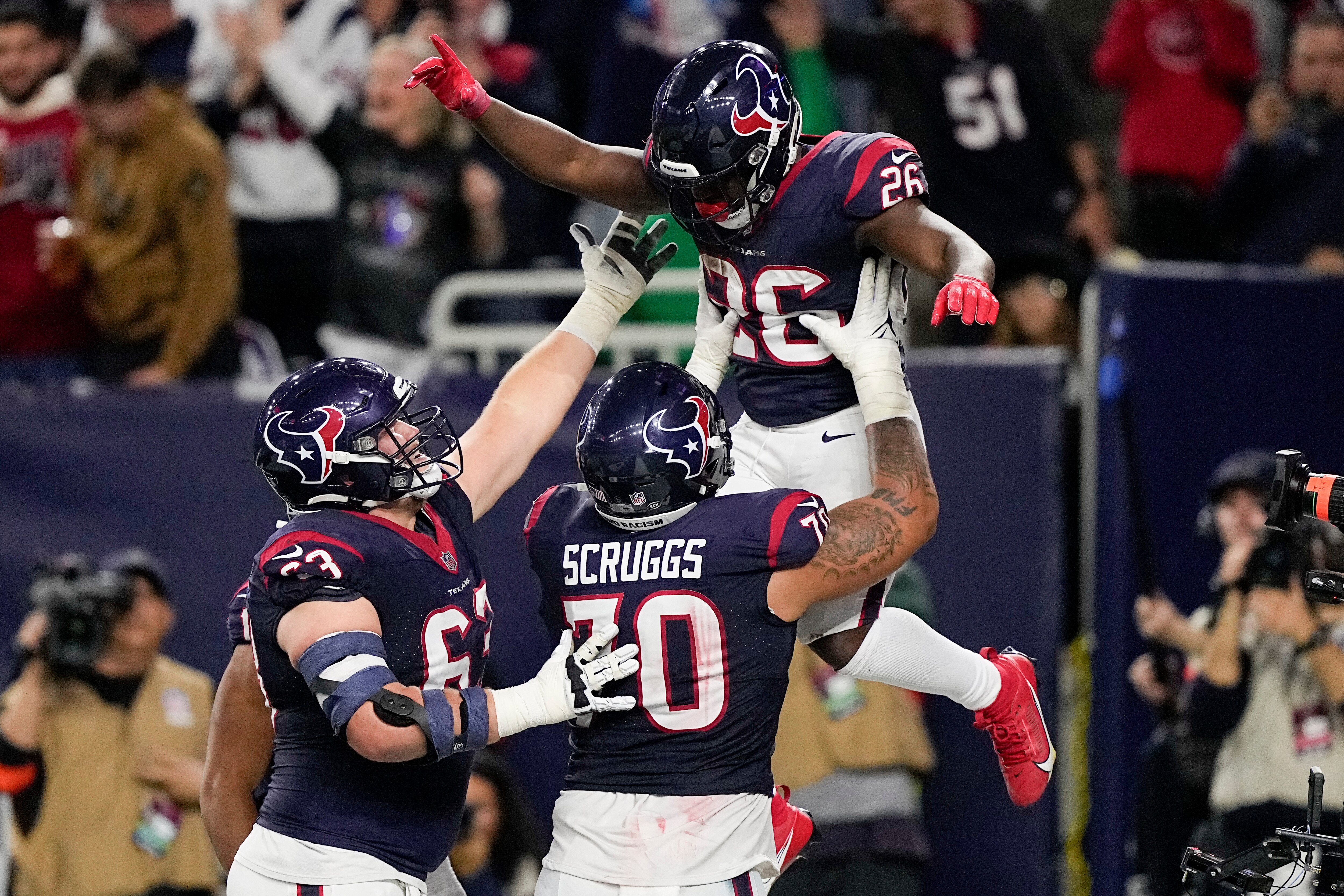 Texans running back Devin Singletary catches a lift from teammates after his fourth-quarter touchdown in Houston's 45-14 win over the Browns on Saturday.