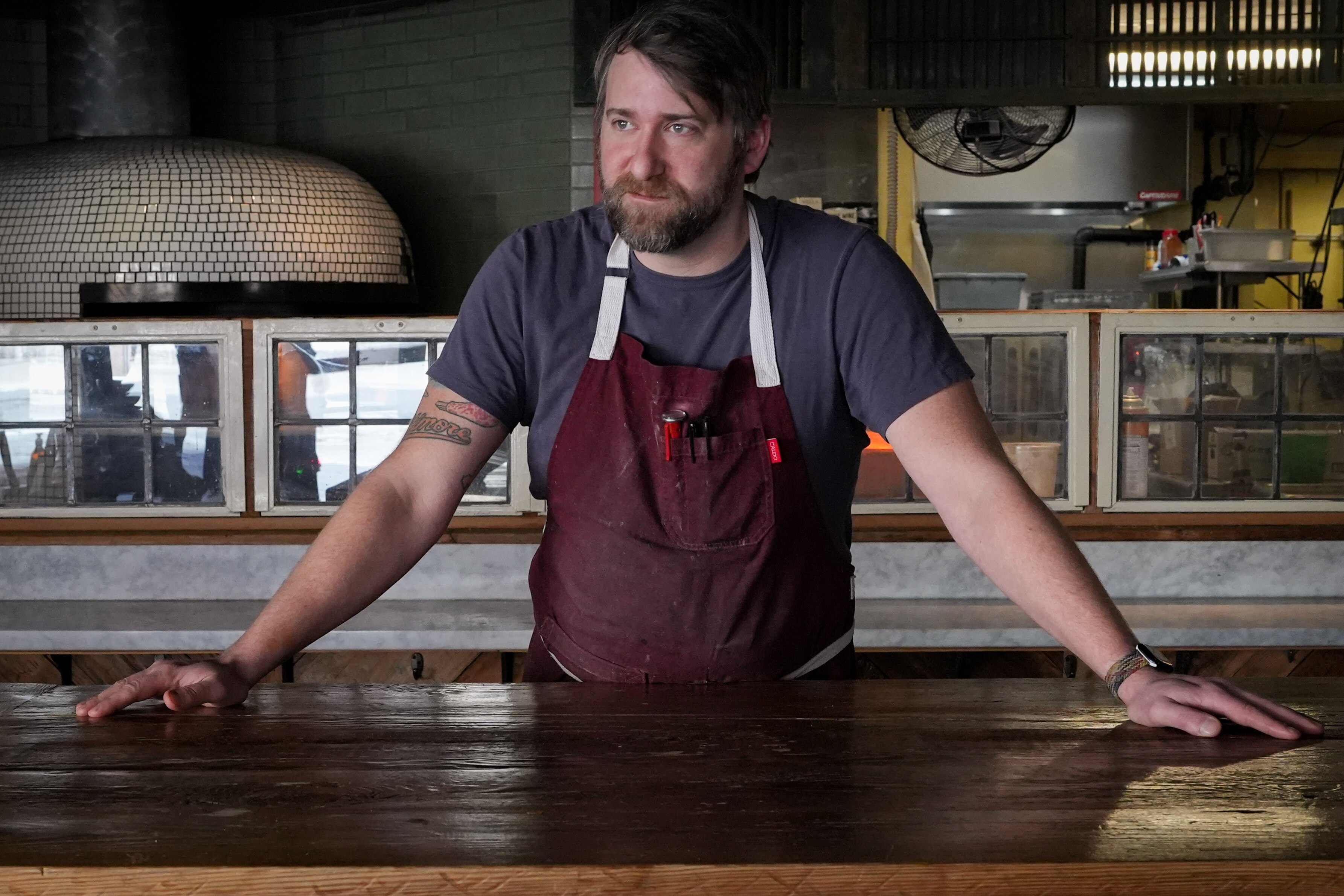 Ricky Johnson, owner and chef at Forno Restaurant and Wine Bar, stands for a portrait inside his restaurant on Monday, March 21. Johnson is one of several property and business owners who say they have concerns about the low levels of foot traffic in the district, which they need to stay in business.