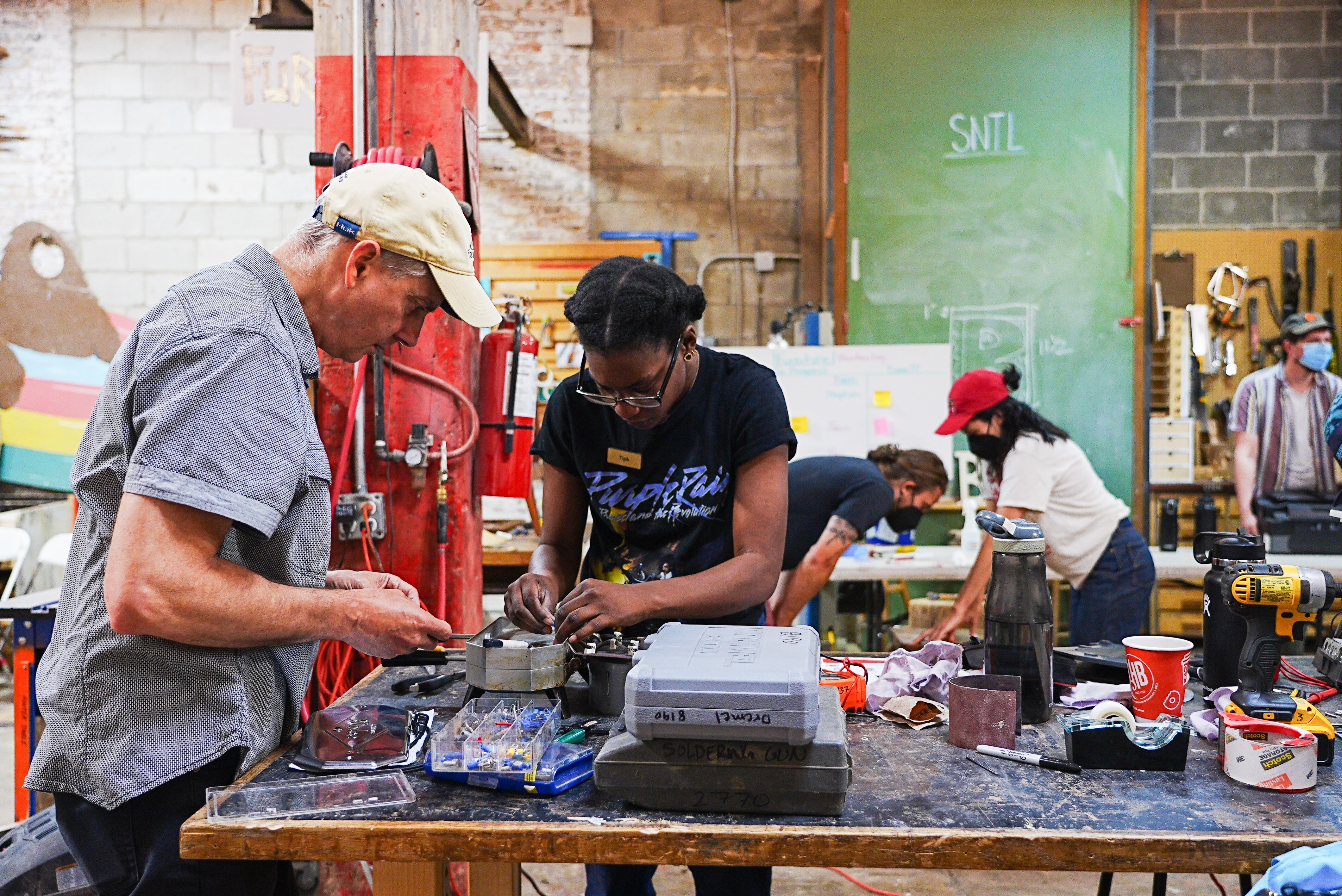 Tiph Browne works on a repair at the Station North Tool Library’s Fix-It Fair in Spring 2023.