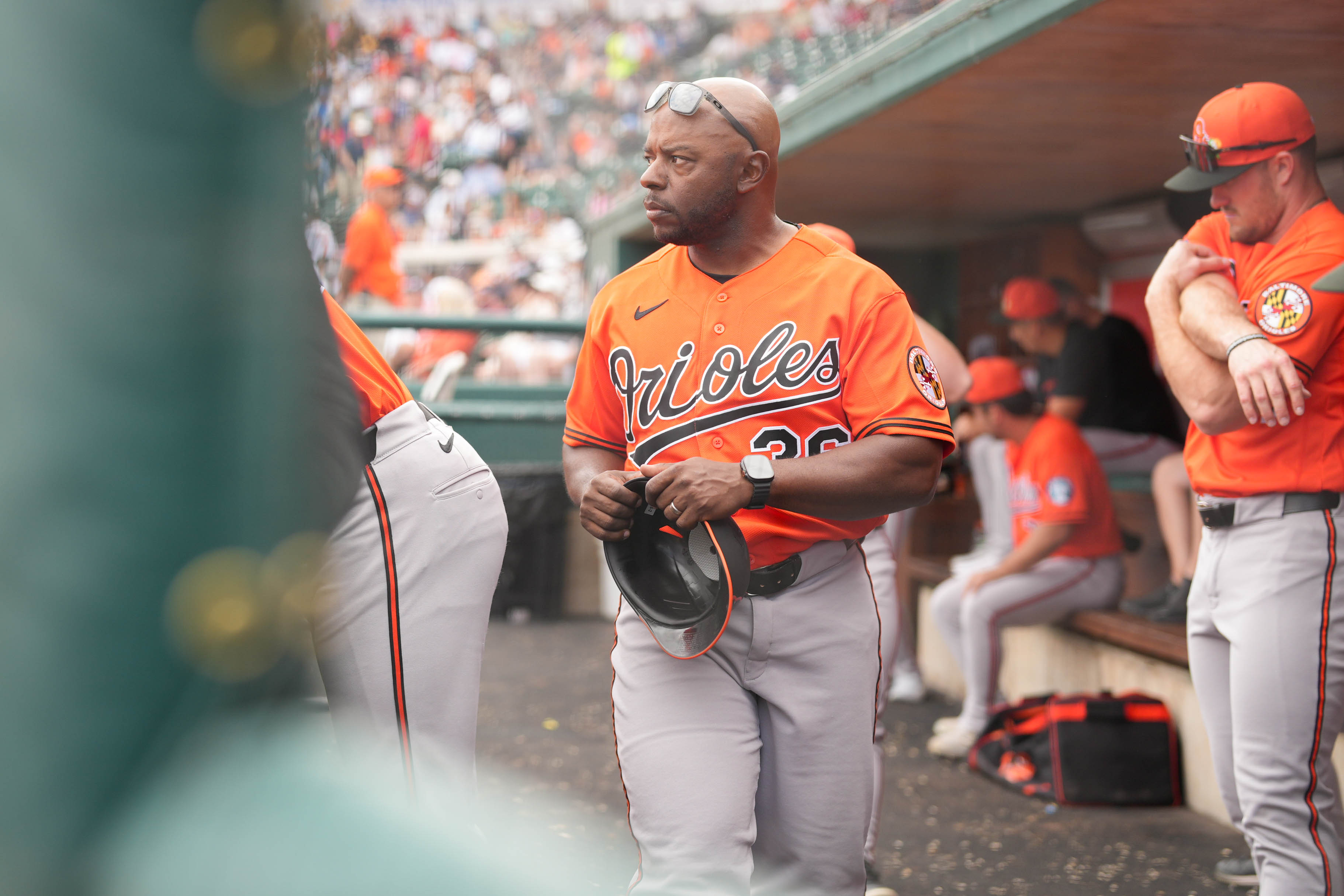 Baltimore Orioles first base coach Jason Bourgeois, center, walks through the dugout in the fourth inning of a spring training game against the Detroit Tigers in February.
