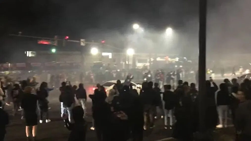 A crowd gathers for alleged exhibition driving in Maryland on a recent weekend.