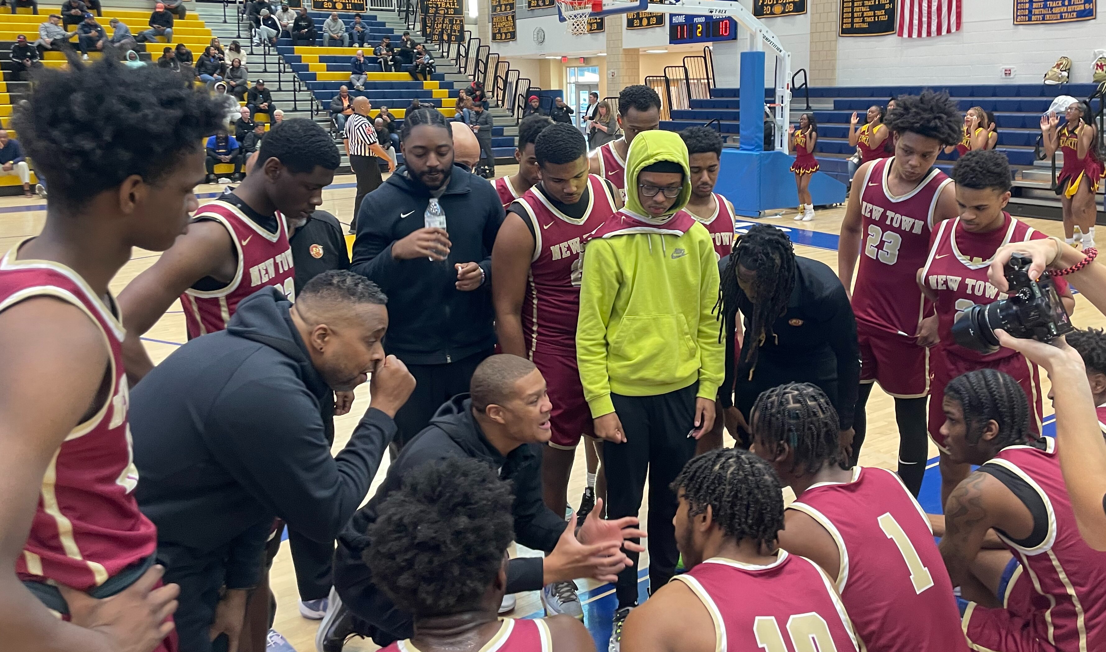 New Town boys basketball coach 
Derek Wise (kneeling) gives instructions during Tuesday's Class 2A state semifinal match with Wicomico. The No. 4 Titans advanced to Thursday's state final with a 47-41 victory over Wicomico at Henry A. Wise in Prince George's County.
