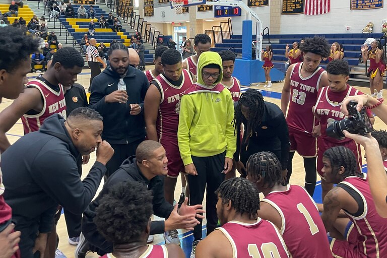 New Town boys basketball coach
Derek Wise (kneeling) gives instructions during Tuesday's Class 2A state semifinal match with Wicomico. The No. 4 Titans advanced to Thursday's state final with a 47-41 victory over Wicomico at Henry A. Wise in Prince George's County.