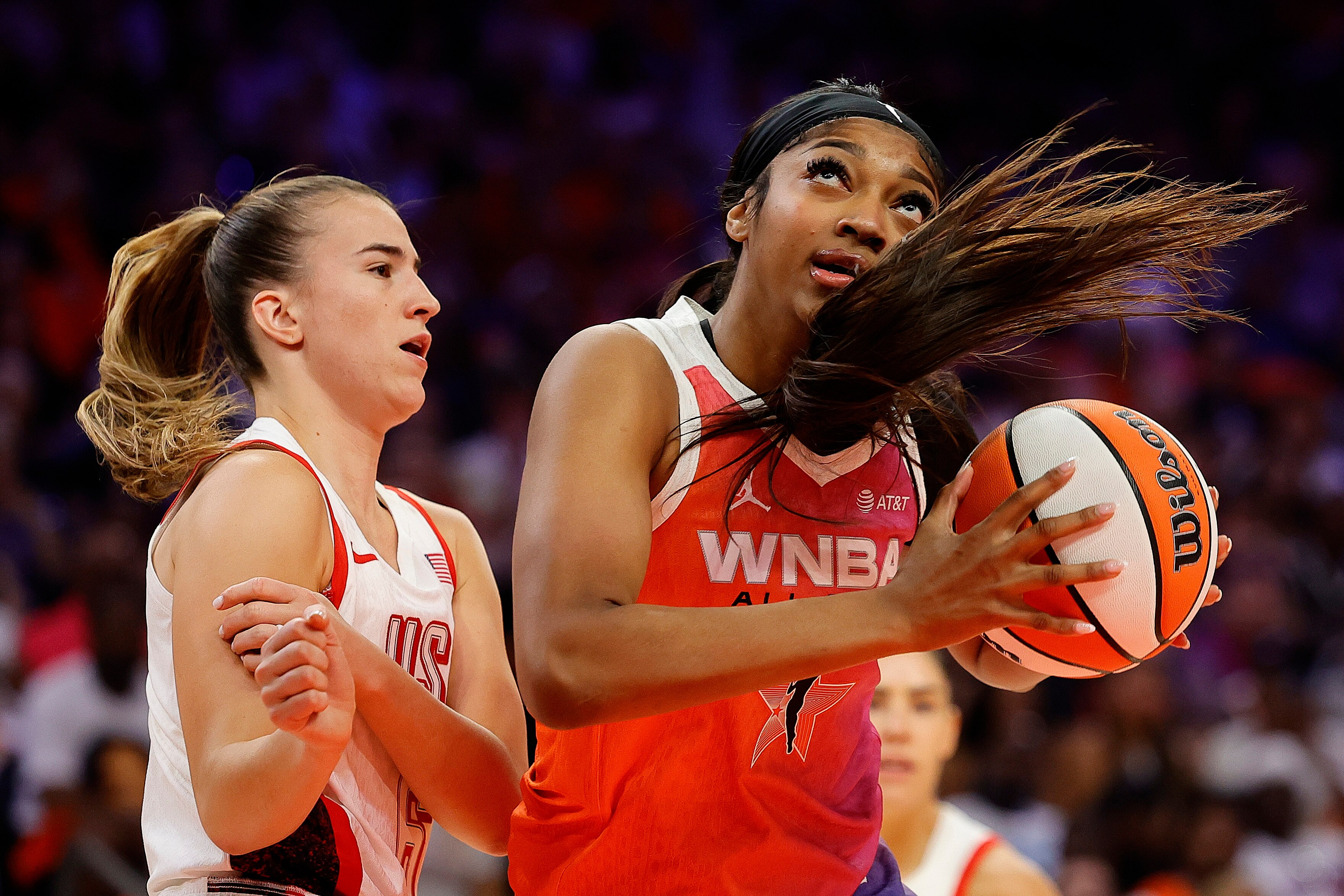 Angel Reese of Team WNBA looks to shoot over Sabrina Ionescu of Team USA during the first half Saturday night.
