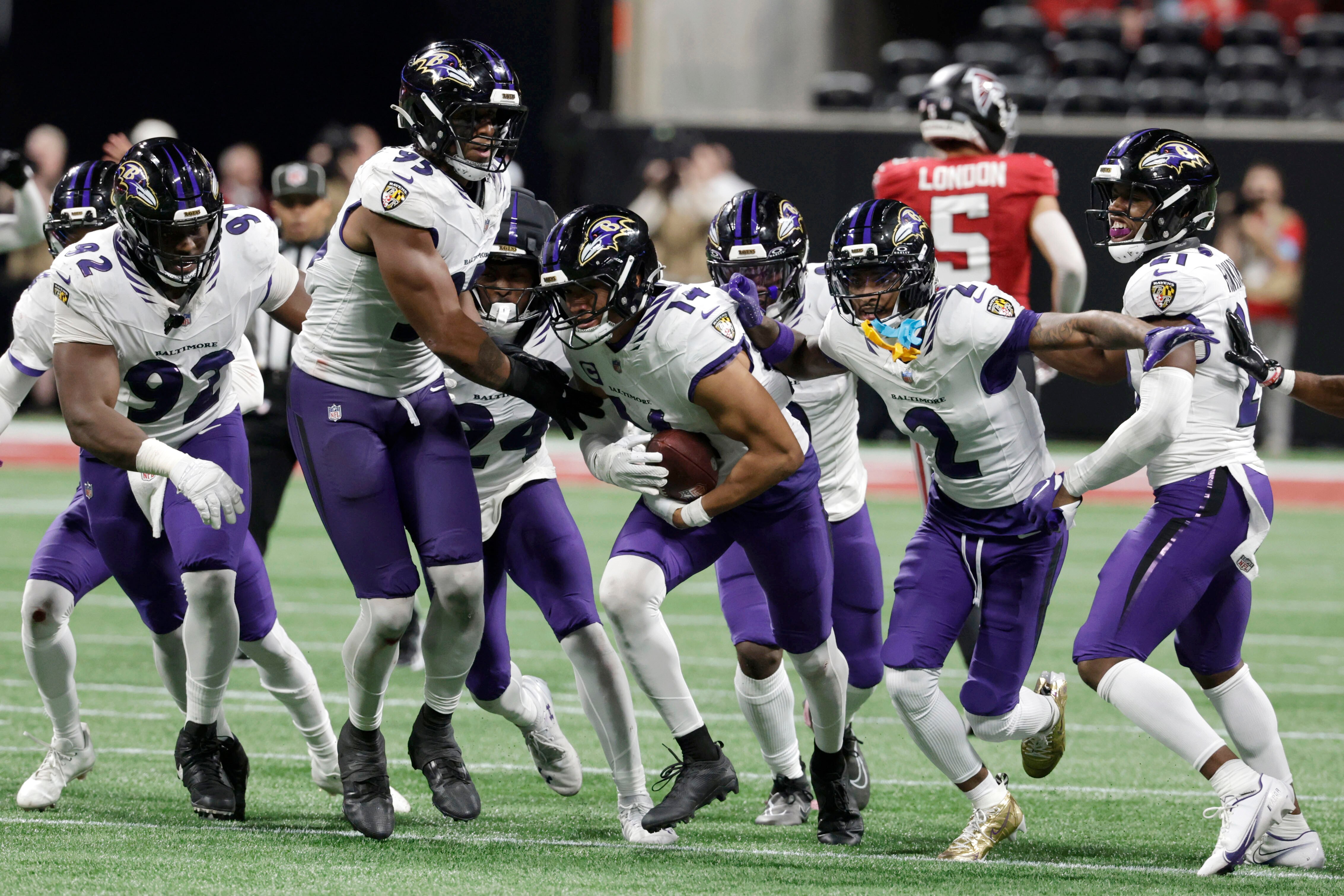 Baltimore Ravens safety Kyle Hamilton (14) celebrates with teammates after intercepting a pass during overtime in a NFL football game against the Atlanta