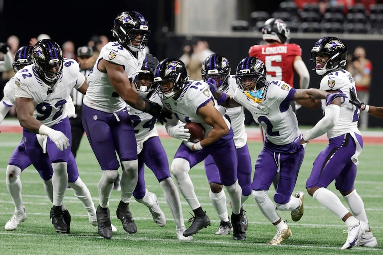 Baltimore Ravens safety Kyle Hamilton (14) celebrates with teammates after intercepting a pass during overtime in a NFL football game against the Atlanta