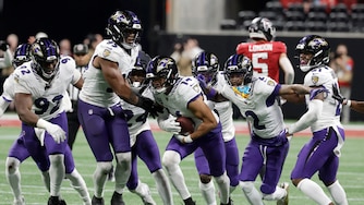 Baltimore Ravens safety Kyle Hamilton (14) celebrates with teammates after intercepting a pass during overtime in a NFL football game against the Atlanta