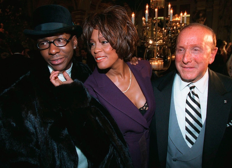 Bobby Brown, left, and Whitney Houston appear with music producer Clive Davis, right, at a pre-Grammy party in New York on Feb. 24, 1998.