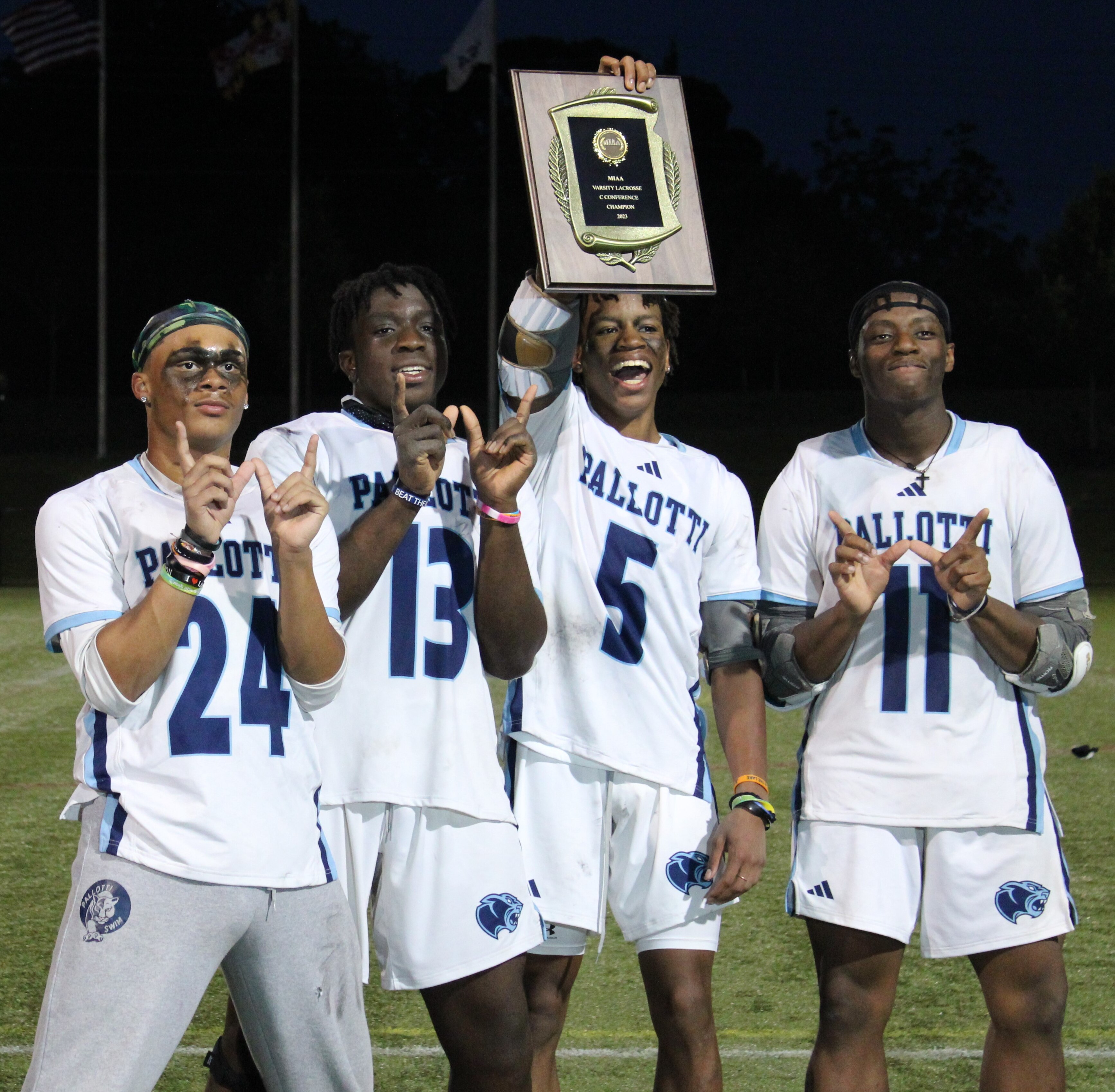 St. Vincent Pallotti's Amir Young holds up the MIAA C Conference lacrosse championship plaque alongside fellow captains Jace Wiggins (left), Ade Adeyemo and Robert Mitchell Thursday evening. The Panthers defeated St. John's Catholic Prep at Tierney Field in Sparks for their first title since 2016.