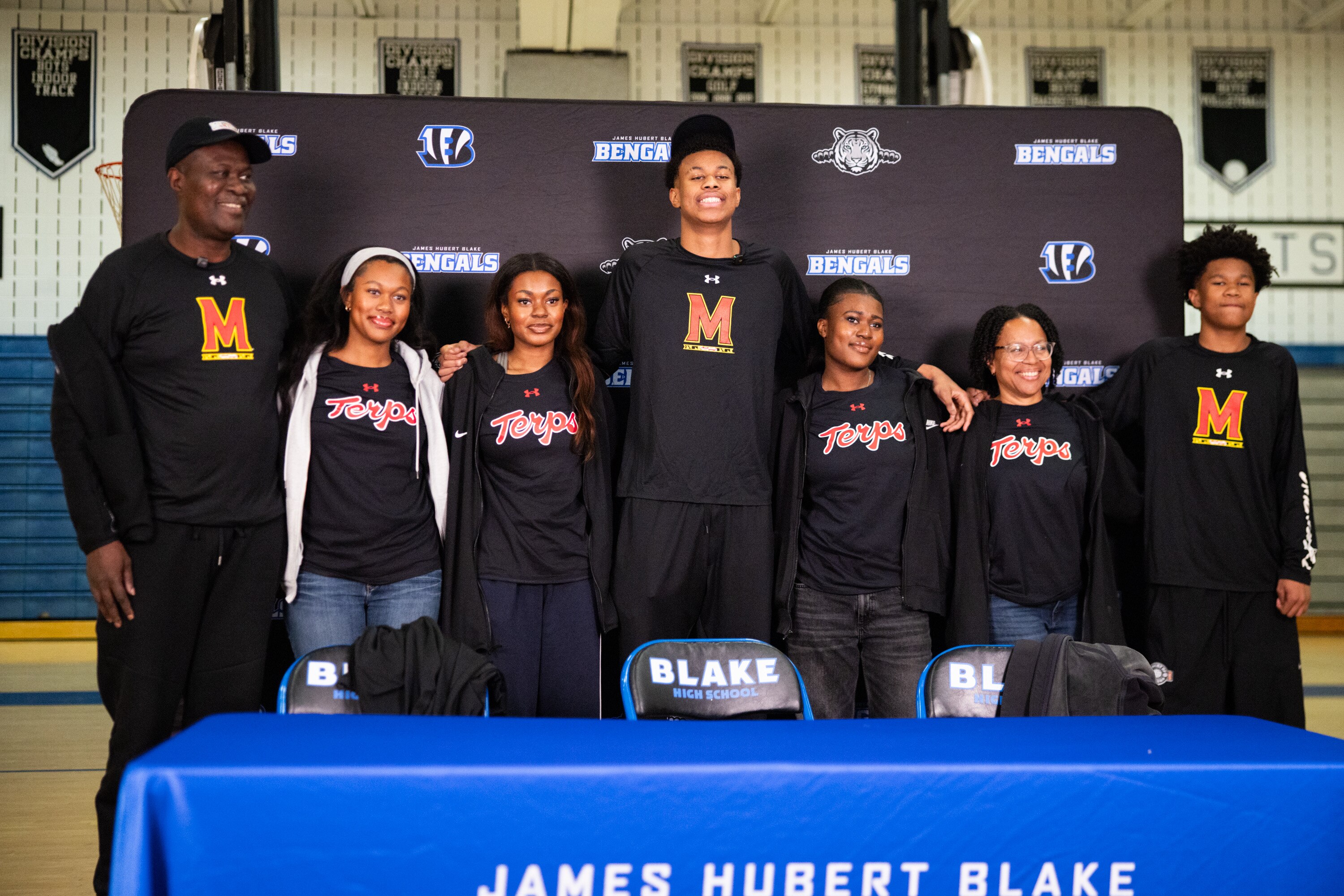Blake High School’s Baba Oladotun celebrates with his family at the Blake High School gym as he commits to attending the University of Maryland on Wednesday, November 19, 2025.