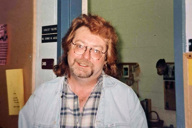 Harvey Doster standing in front of a theater classroom.