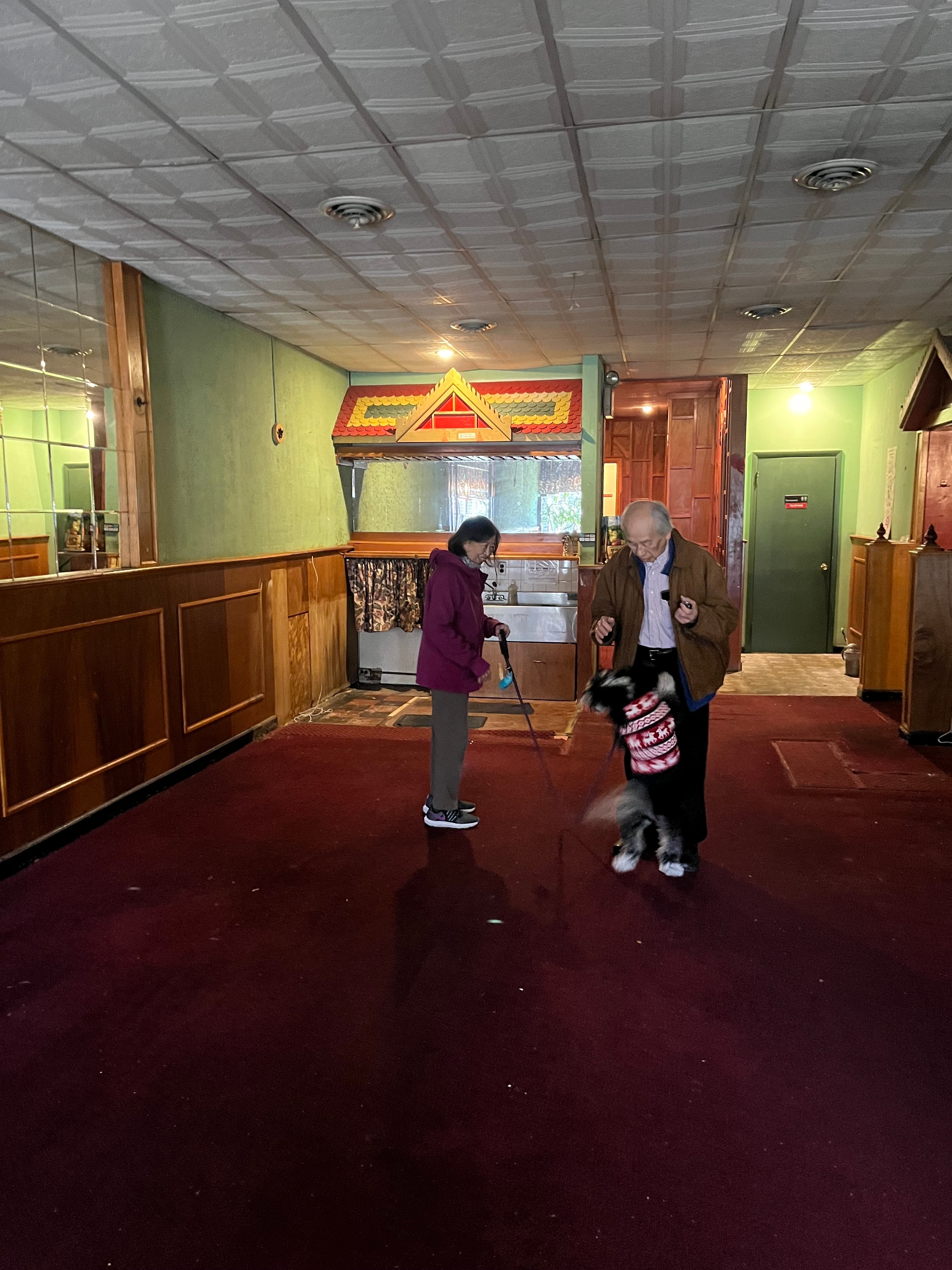 Billy and Soy stand Tuesday in an empty dining room that once served the Waverly neighborhood for 43 years.