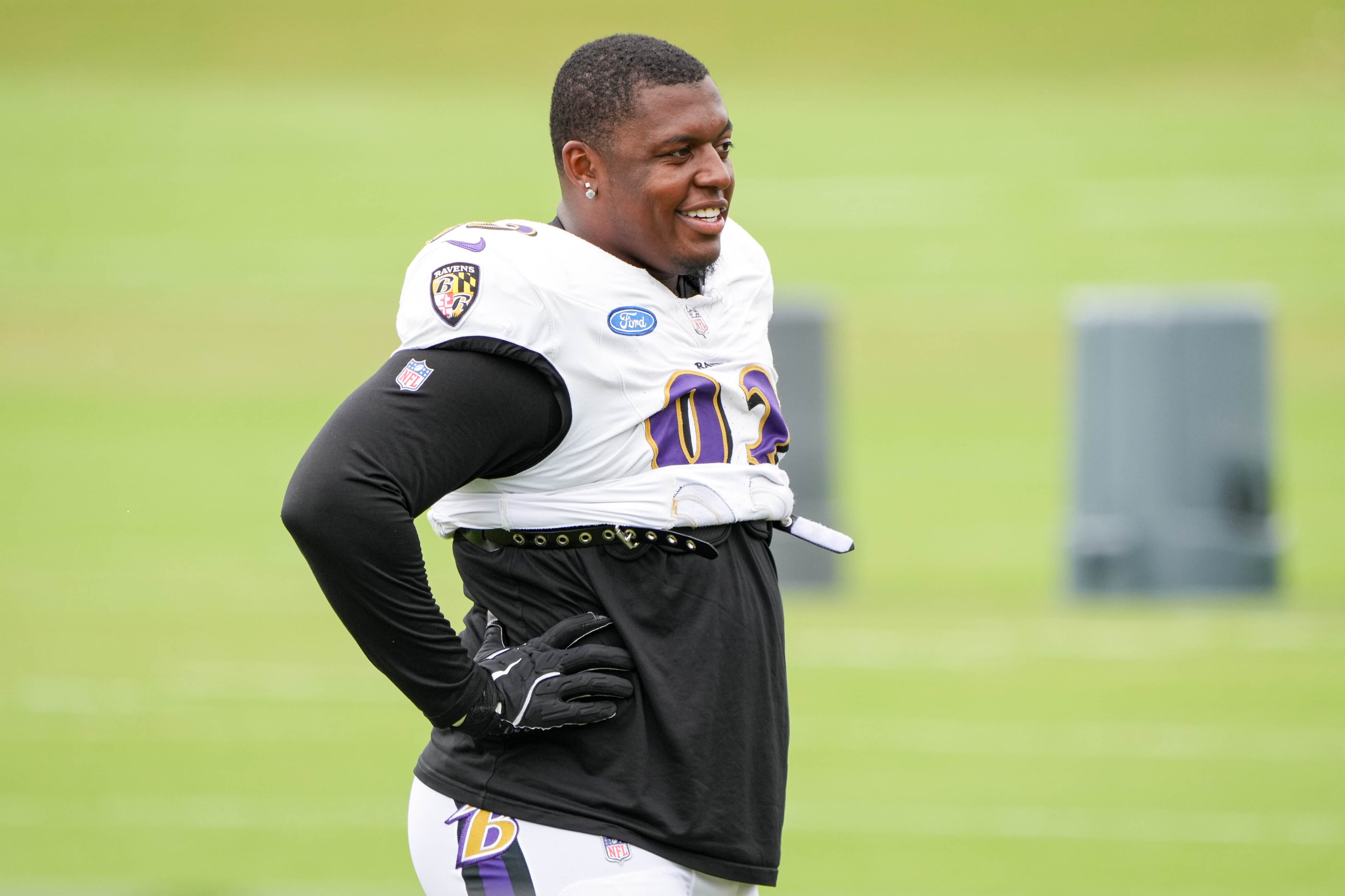 Ravens defensive lineman Aeneas Peebles (93) smiles after completing a drill during the team’s training camp on Aug. 19.