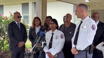Deputy Shief Shawné Waddy and Asst. Dep. Chief Jason Fisher address the media in front of Arrowhead Elementary School during a news conference about a public suicide death.