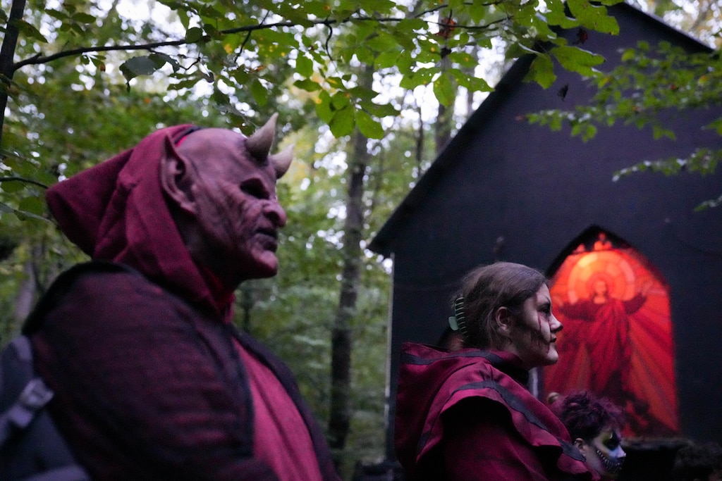 Banner reporter Hannah Yasharoff , right, and other scare actors attend a team meeting before taking their positions throughout Markoff's Haunted Forest in Dickerson, Md. on Friday, October 9, 2026.