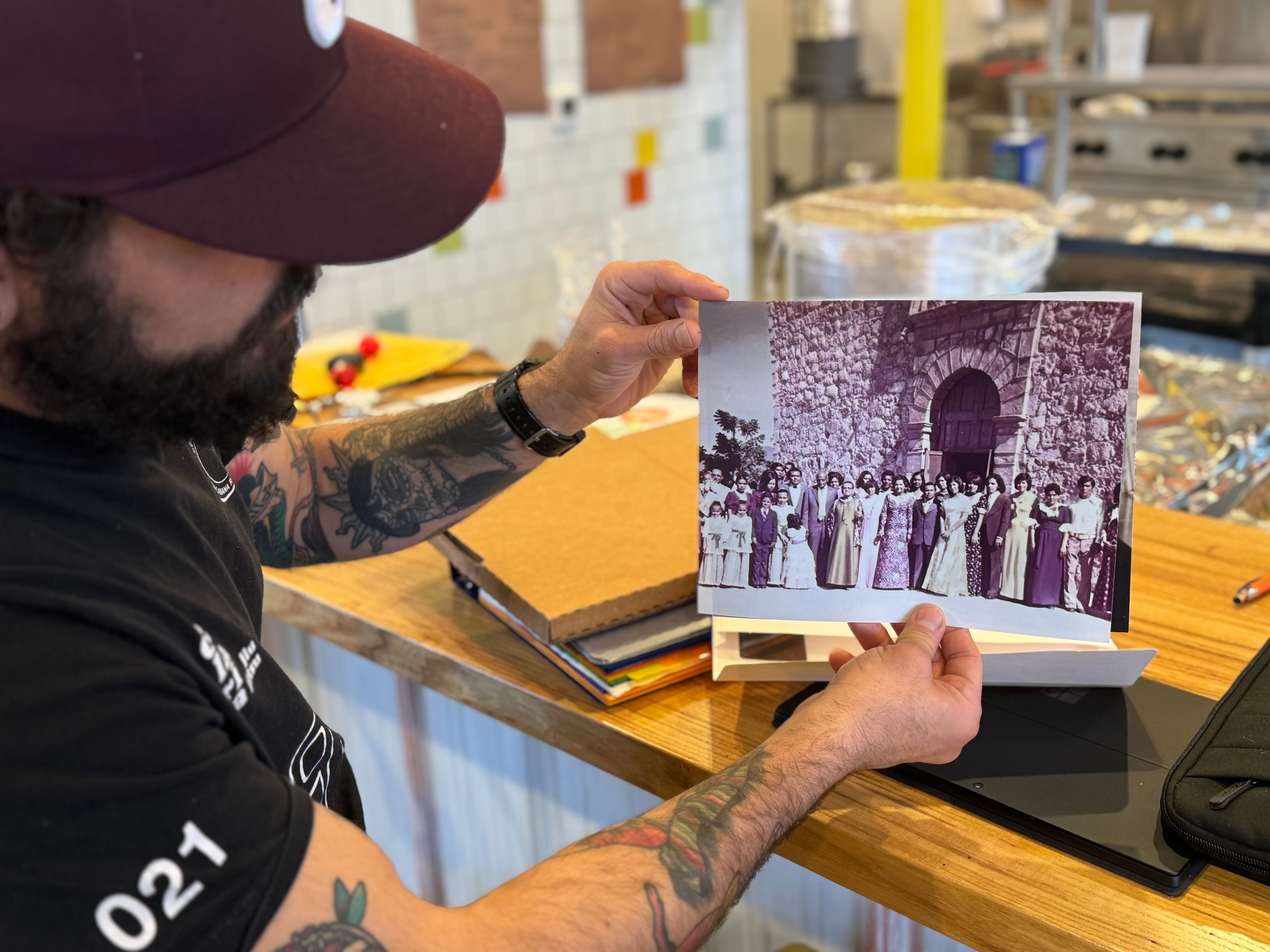 Carlos Raba displays family photos in his new eatery.