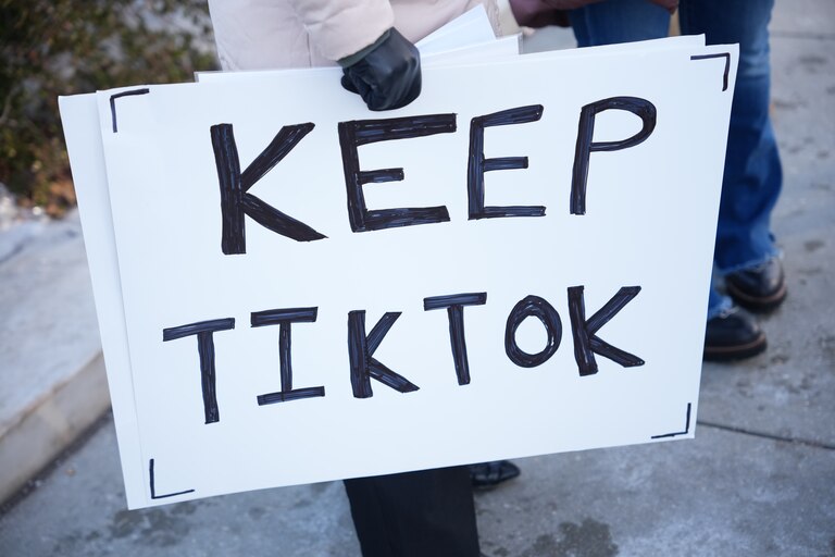 WASHINGTON, DC - JANUARY 10: Sarah Baus of Charleston, S.C., a content creator on TikTok, holds a sign that reads "Keep TikTok" outside the U.S. Supreme Court Building as the court hears oral arguments on whether to overturn or delay a law that could lead to a ban of TikTok in the U.S., on January 10, 2025 in Washington, DC. The future of the popular social media platform is at stake as the Supreme Court hears arguments on a law set to take effect the day before Inauguration Day that would force their China-based parent company to cut ties with TikTok due to national security concerns. (Photo by Andrew Harnik/Getty Images)