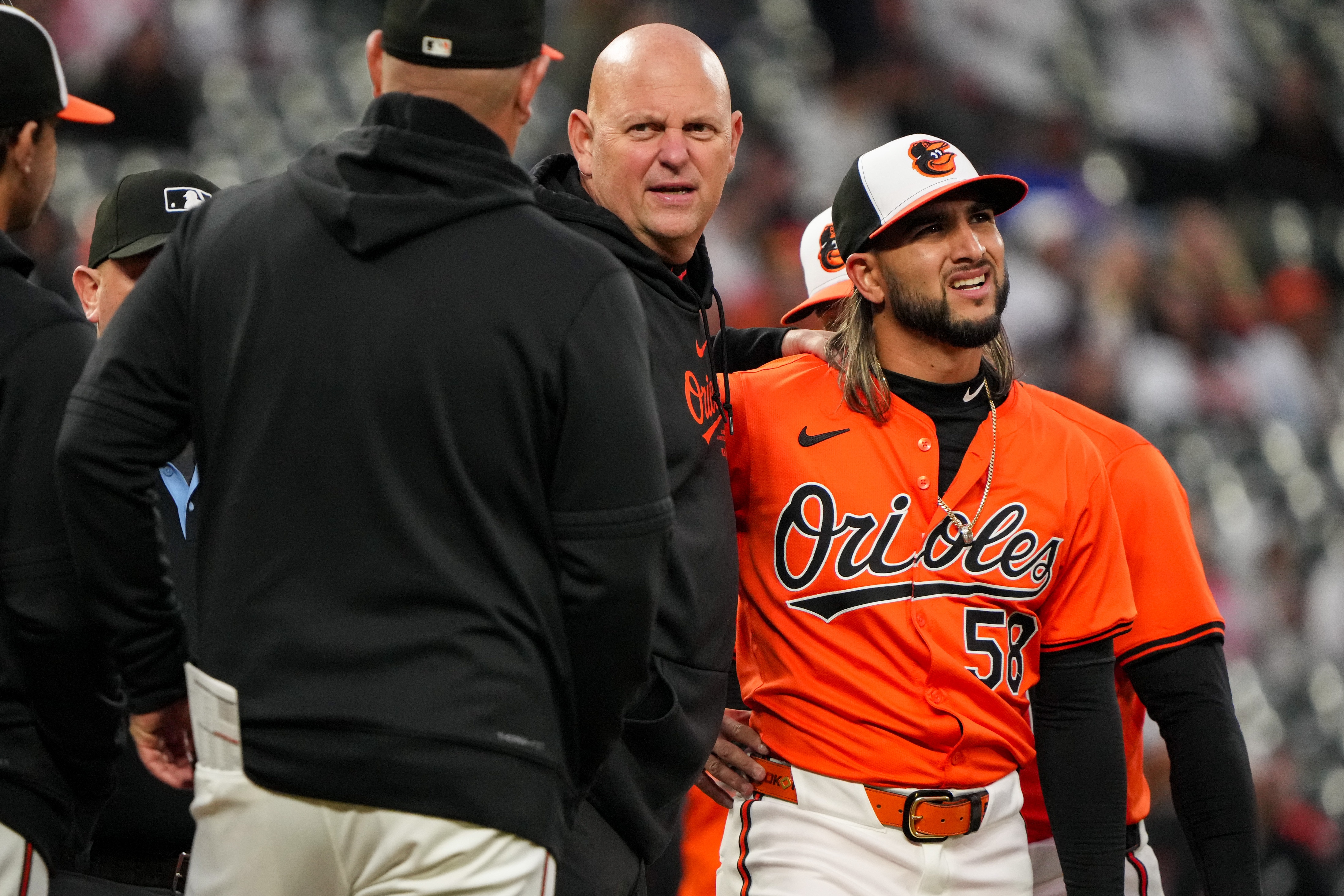 Relief pitcher Cionel Pérez (58) is pulled from the game by head trainer Brian Ebel (middle) against the Los Angeles Angels.