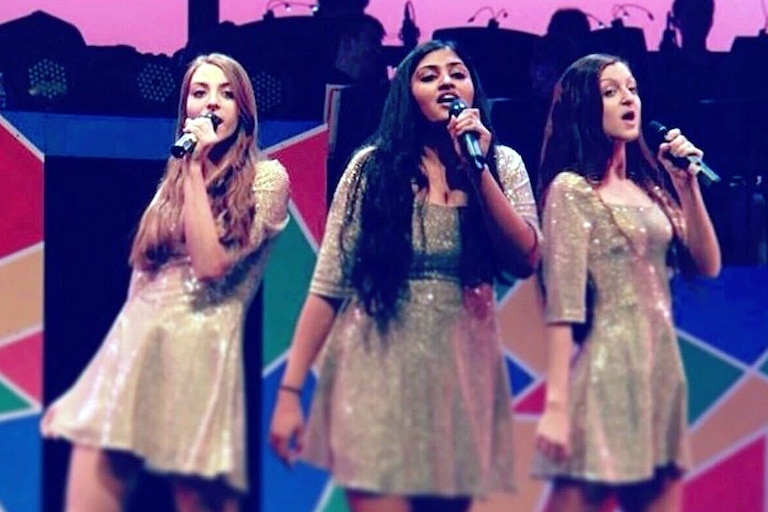 Shreya Navile, center, grew up performing in Potomac, including in Winston Churchill High School’s annual Blast concert.