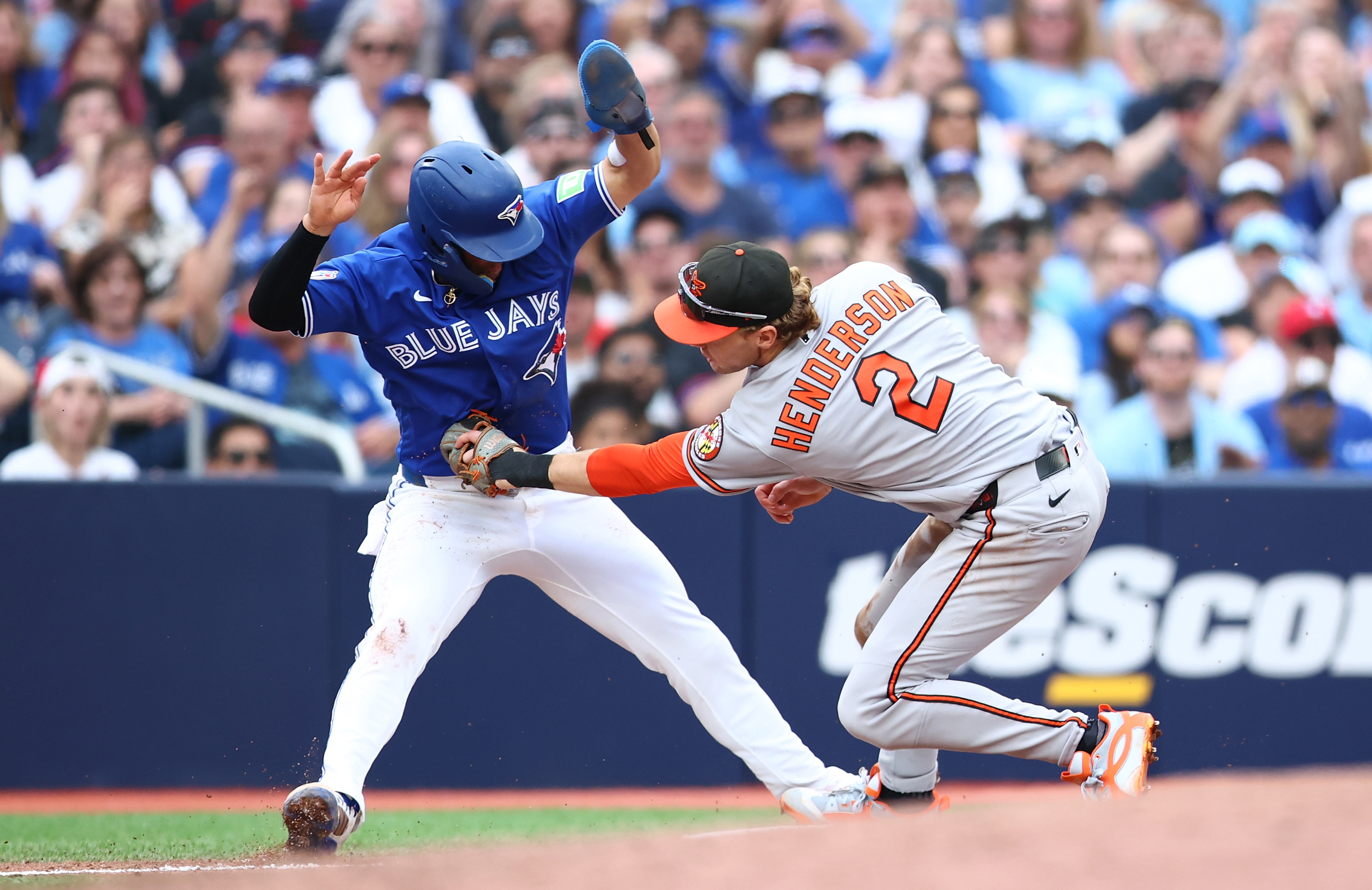 Orioles shortstop Gunnar Henderson tags out Andrés Giménez at third base in the sixth inning after the Blue Jays runner fell for a fake by Christian Encarnacion-Strand.