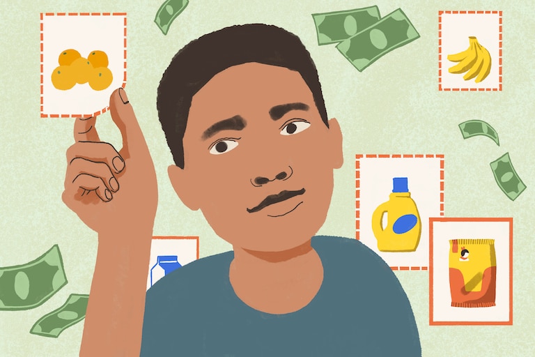 Boy clips a coupon, surrounded by dollar bills and coupons