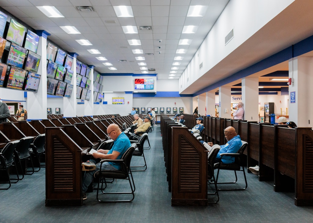 Gamblers review their booklets at Laurel Park Race Track.