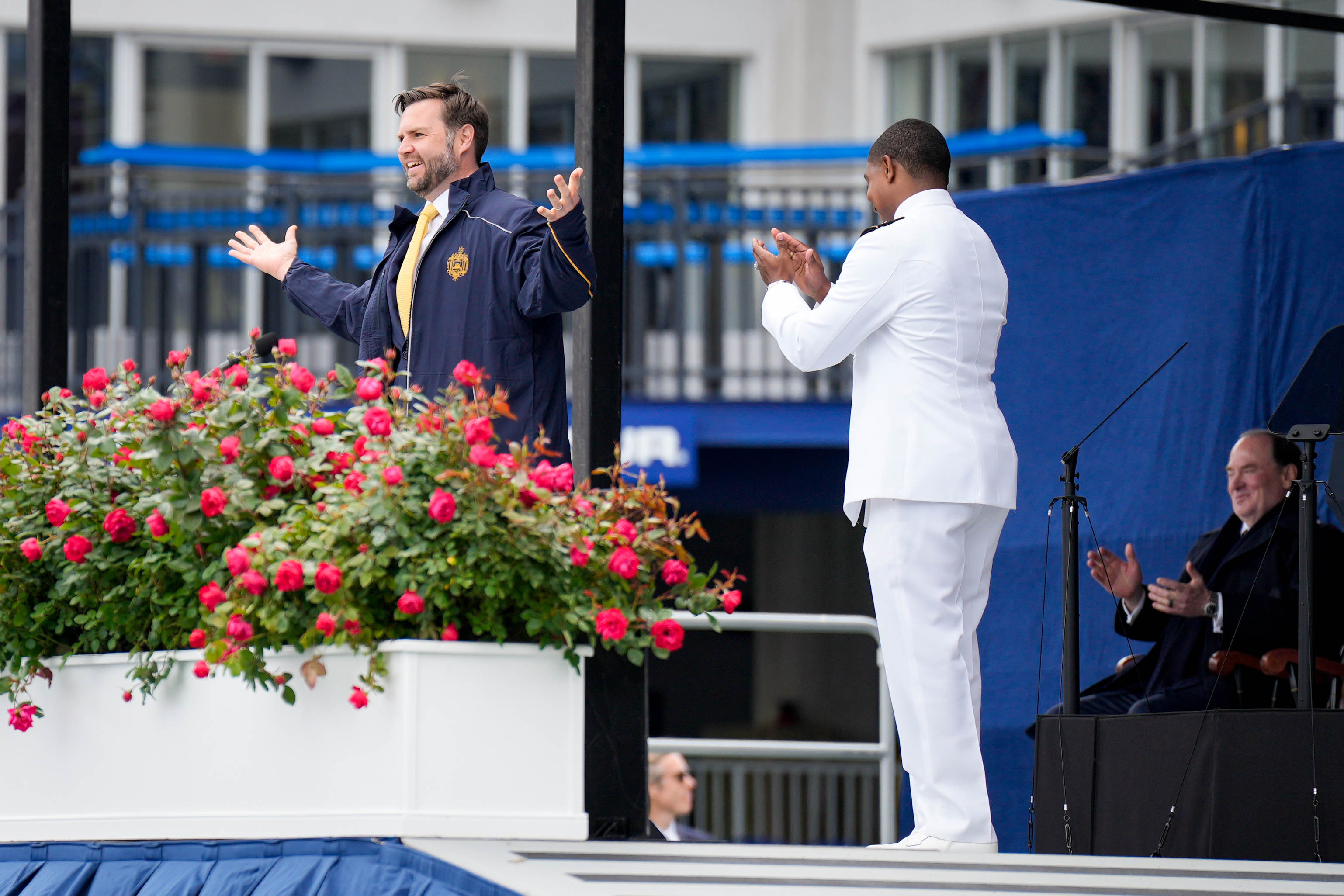 U.S. Vice President JD Vance, left, accepts a gifted jacket from the U.S. Naval Academy Class of 2025 during their graduation ceremony at the Navy-Marine Corps Memorial Stadium in Annapolis, Md. on Friday, May 23, 2025.