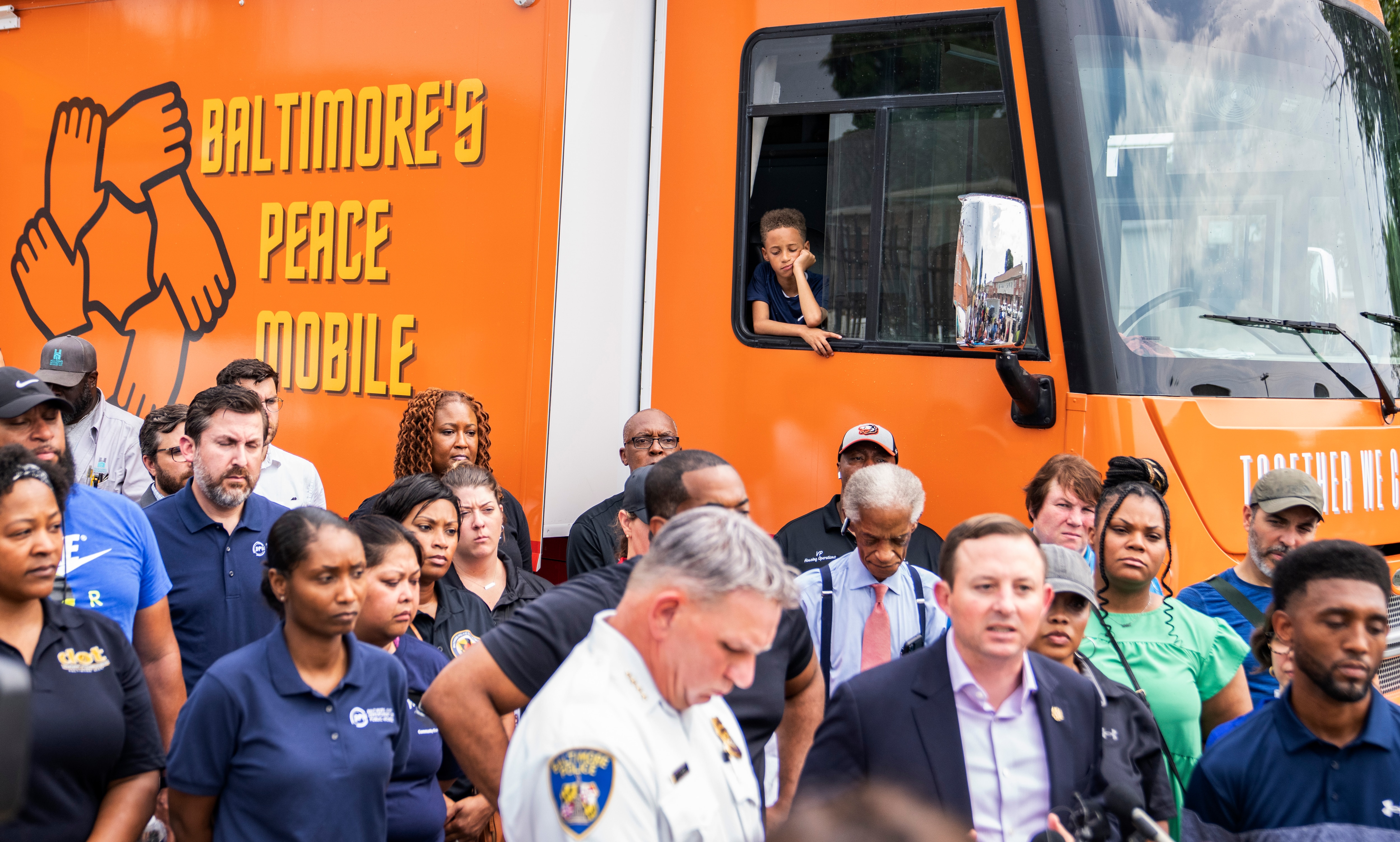 A press conference is held infant of Baltimore’s Peace Mobile near Glade Court in Brooklyn after a shooting early Sunday morning, July 2, 2023.