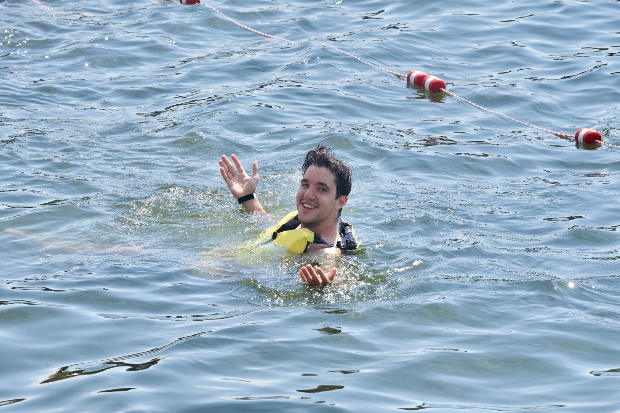 More than 150 people jumped into the water at Bond Street Wharf on June 23, 2024 to raise awareness for a clean and usable waterway. The author, pictured, was one of them. (Kaitlin Newman/The Baltimore Banner)