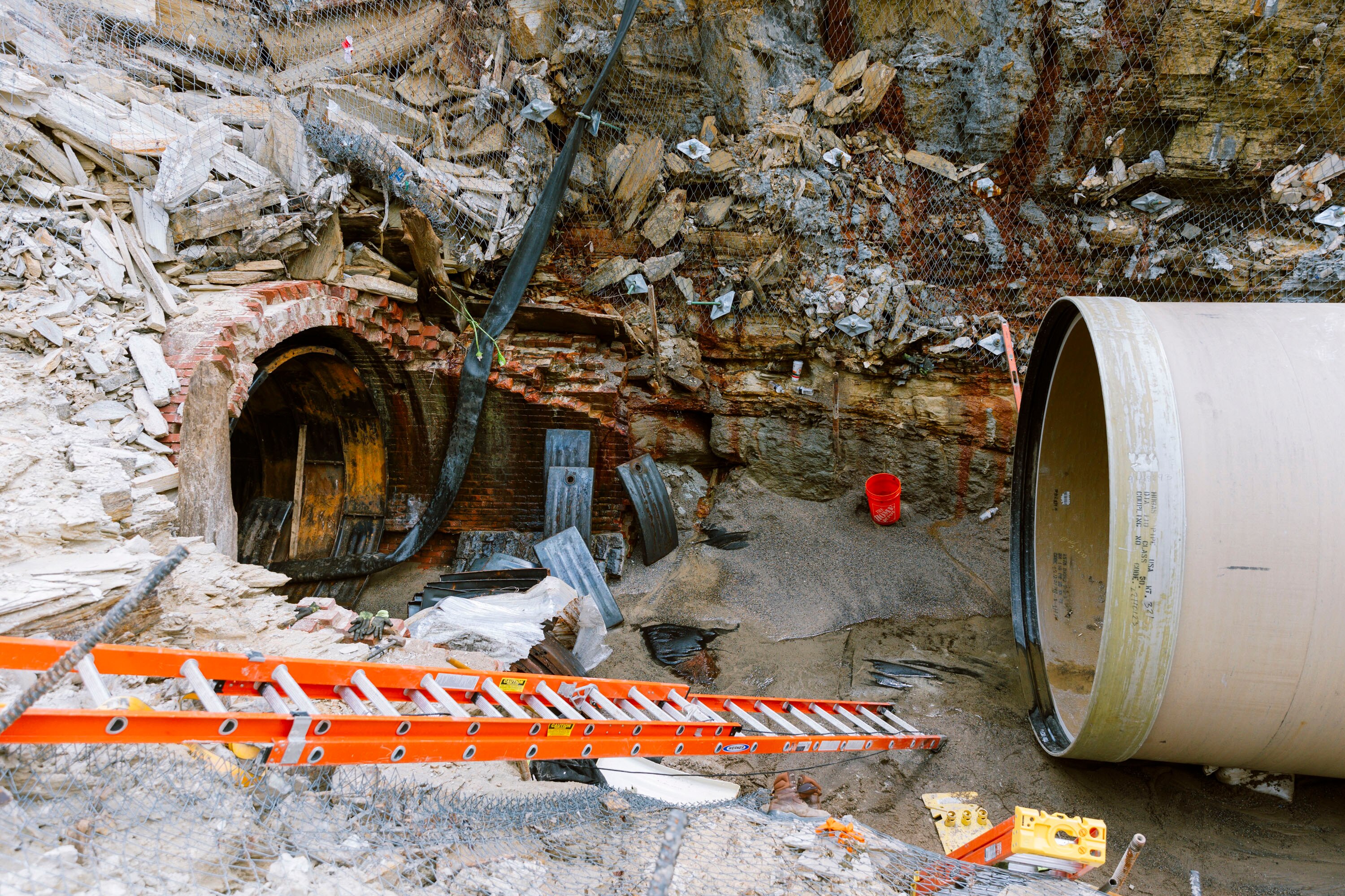 The new steel and cement replacement pipe, right, is seen next the to an opening in the multilayered brick pipe which was built from the inside over 140 years ago at Lake Montebello on Thursday, Aug. 22, 2024 in Baltimore.