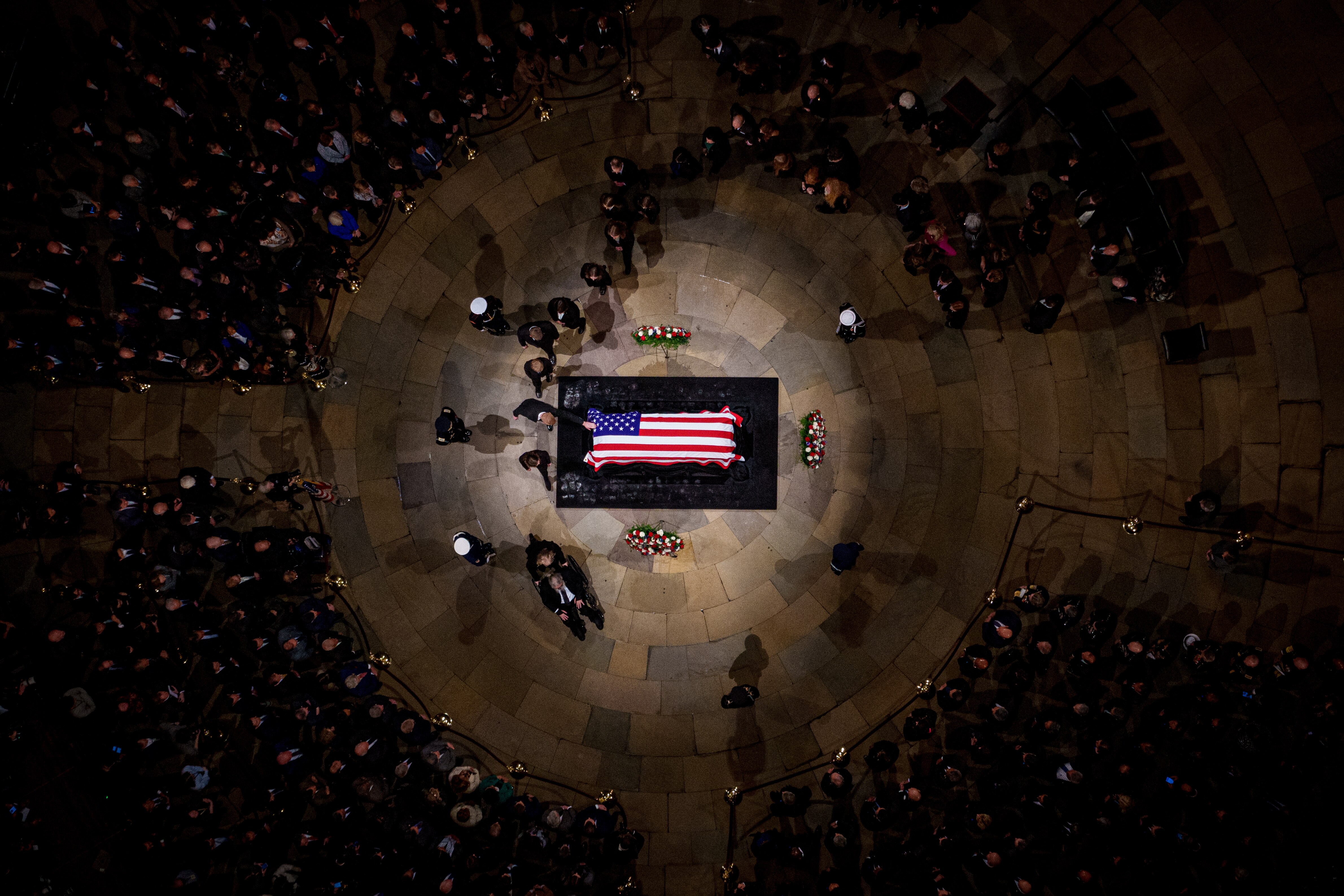 A family member touches the flag-draped casket of former President Jimmy Carter as he lies in state in the U.S. Capitol Rotunda on Tuesday in Washington, D.C.