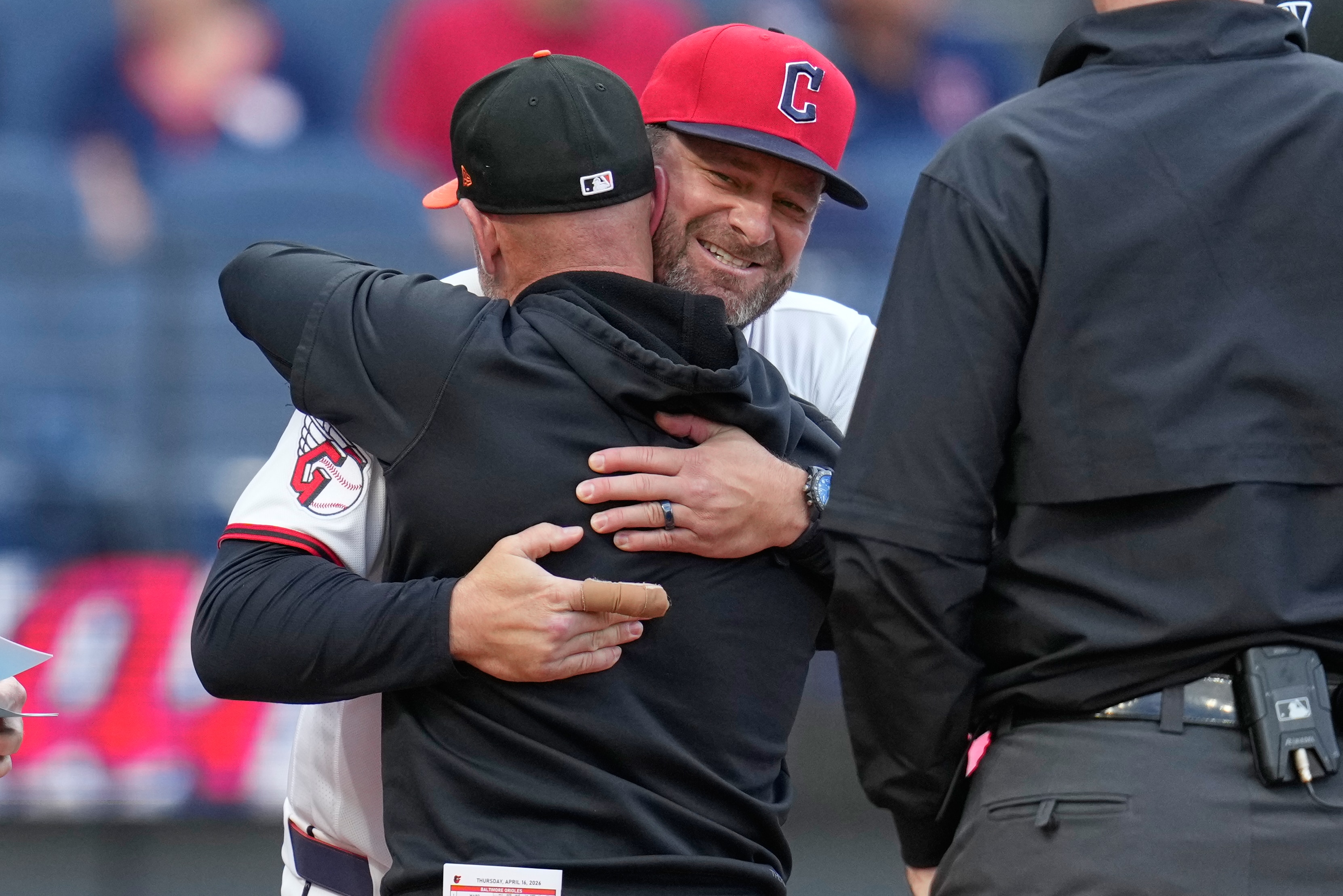 Cleveland Guardians manager Stephen Vogt, rear, embraces Craig Albernaz, front, former Guardians coach and current Baltimore Orioles manager.