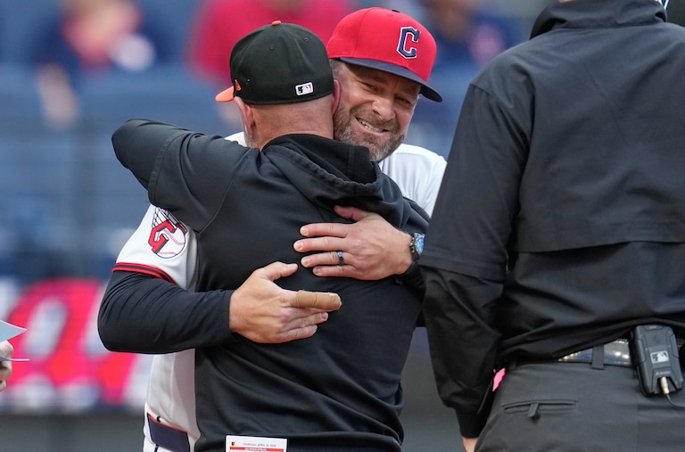 Cleveland Guardians manager Stephen Vogt, rear, embraces Craig Albernaz, front, former Guardians coach and current Baltimore Orioles manager.