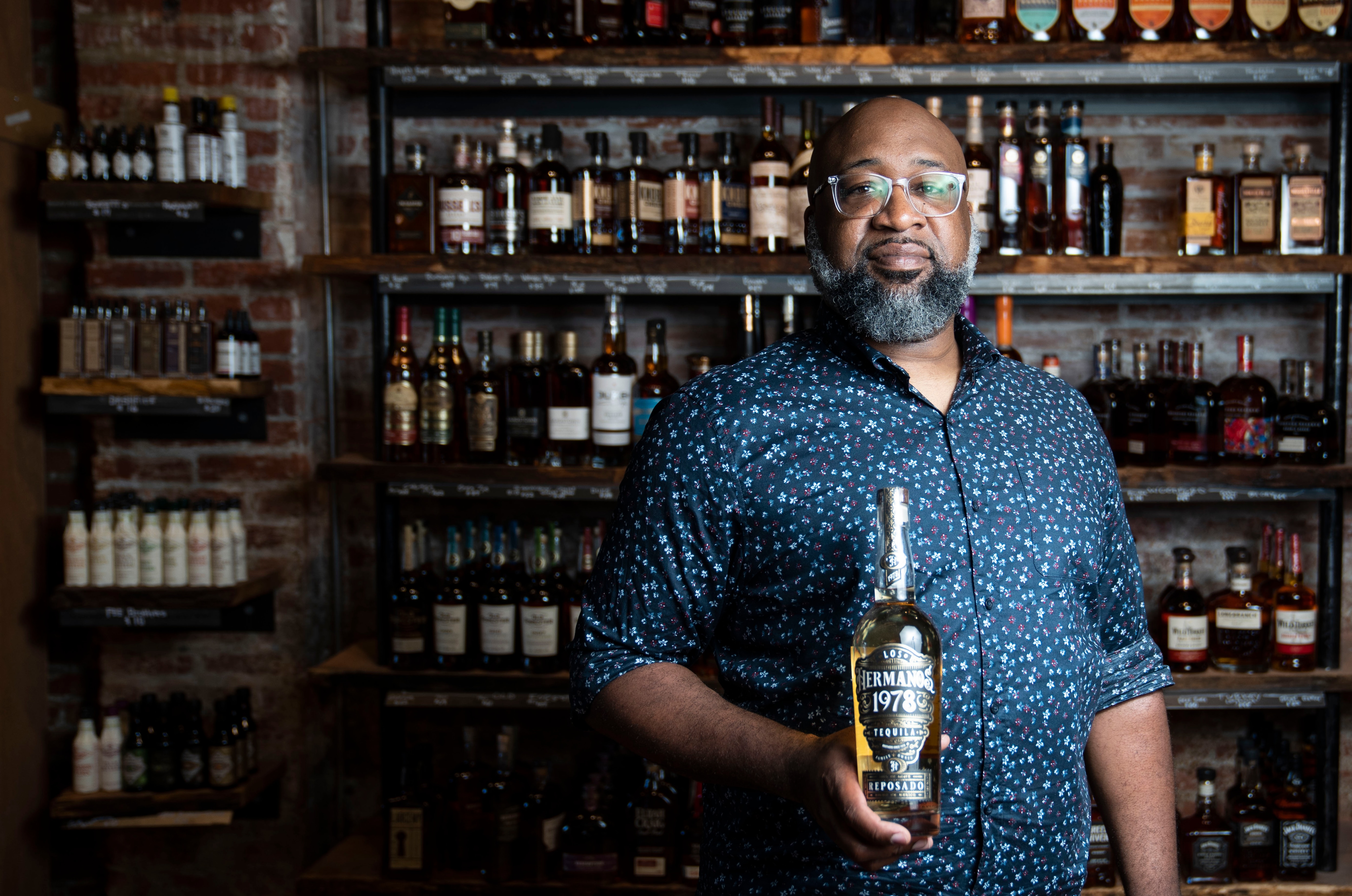 Donta Henson poses for a portrait with his tequila, Los Hermanos 1978 Tequila, at Lighthouse Canton, on July 3, 2024.