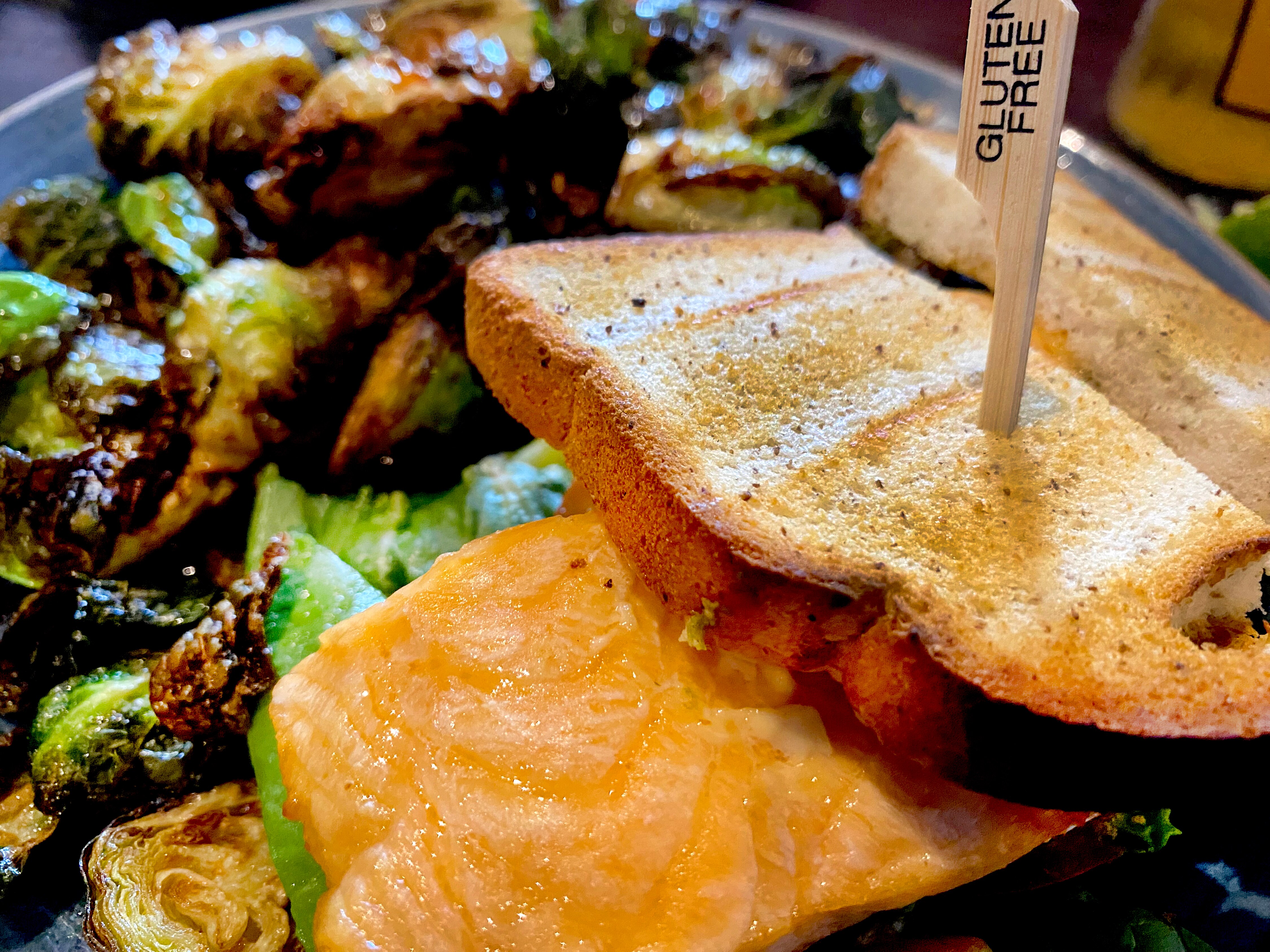 Alexander’s Tavern in Fells Point offers a separate gluten free menu, which includes many of the same items are the regular menu with gluten free bread and crust substitutes.  The salmon BALT sandwich comes with a gluten free flag.