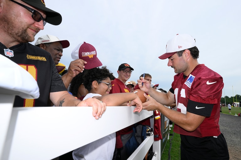 Washington Commanders kicker Jake Moody signs for fans at training camp on Aug. 1.