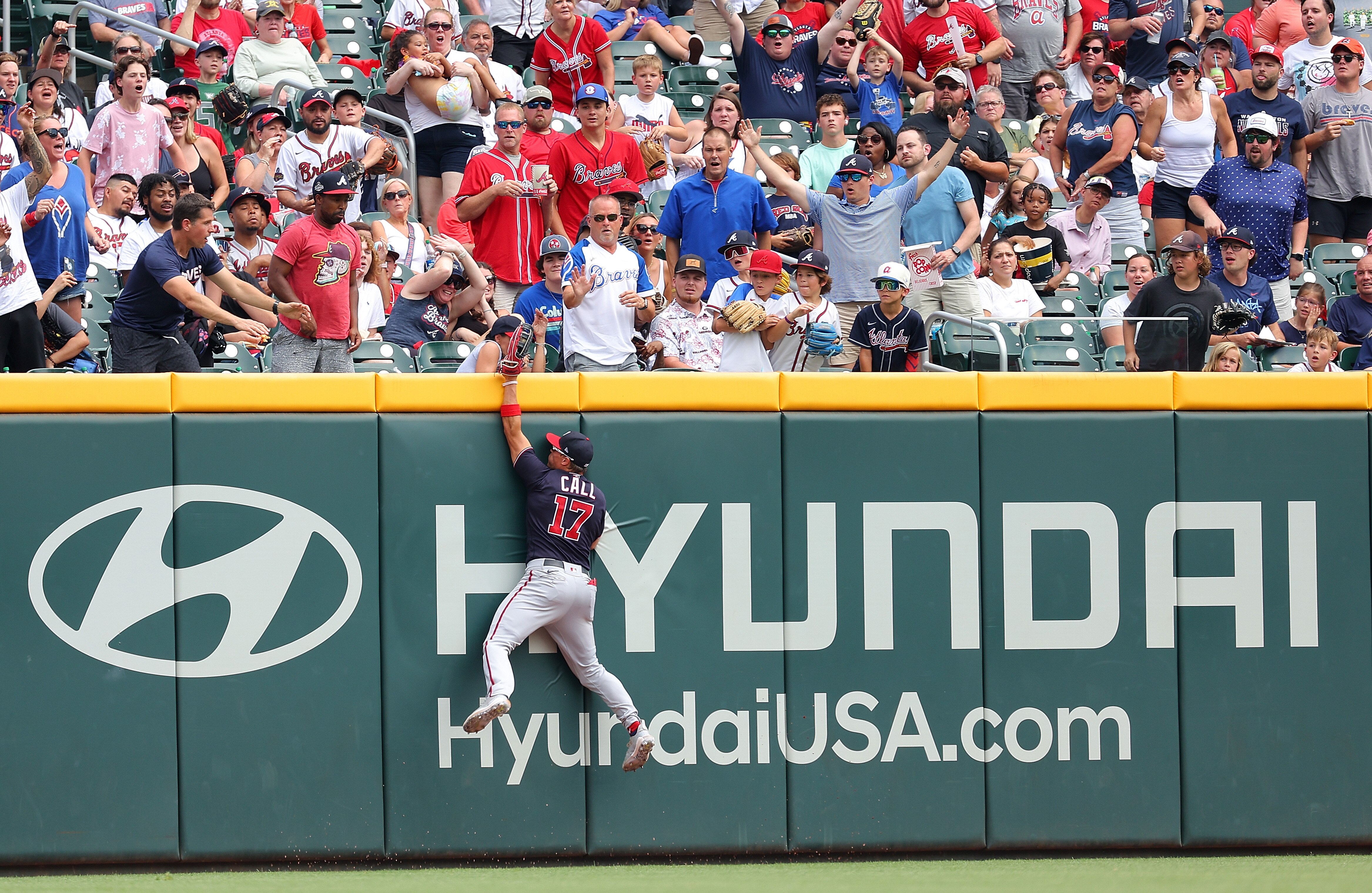 Washington's Alex Call makes a leaping catch at the wall on a ball hit by Michael Harris II of the Braves to end the sixth inning at Truist Park.