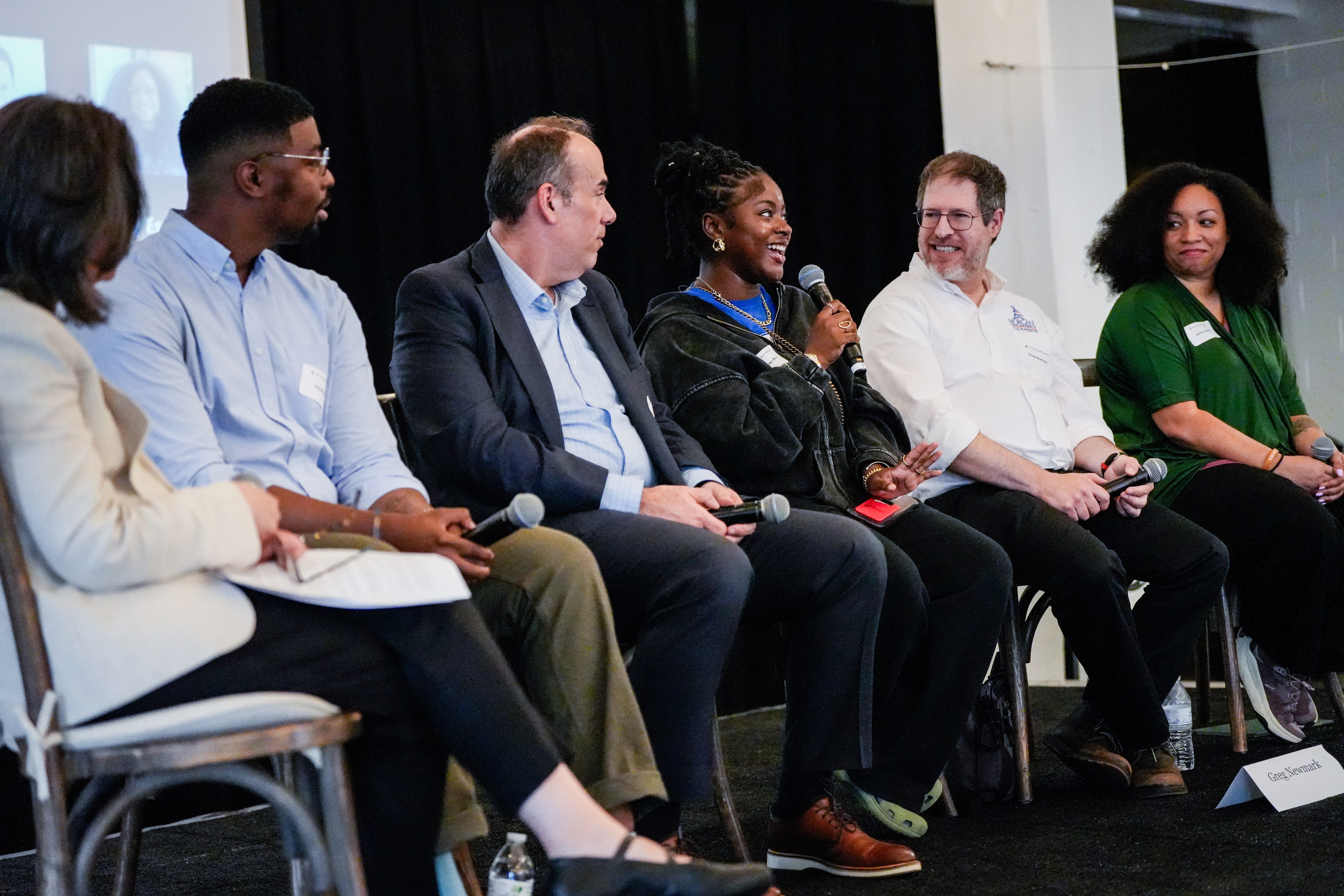 Brooke Bourne, center, a senior at Western High School, answers a question from the audience during Monday evening’s community discussion on the Baltimore student transportation crisis.