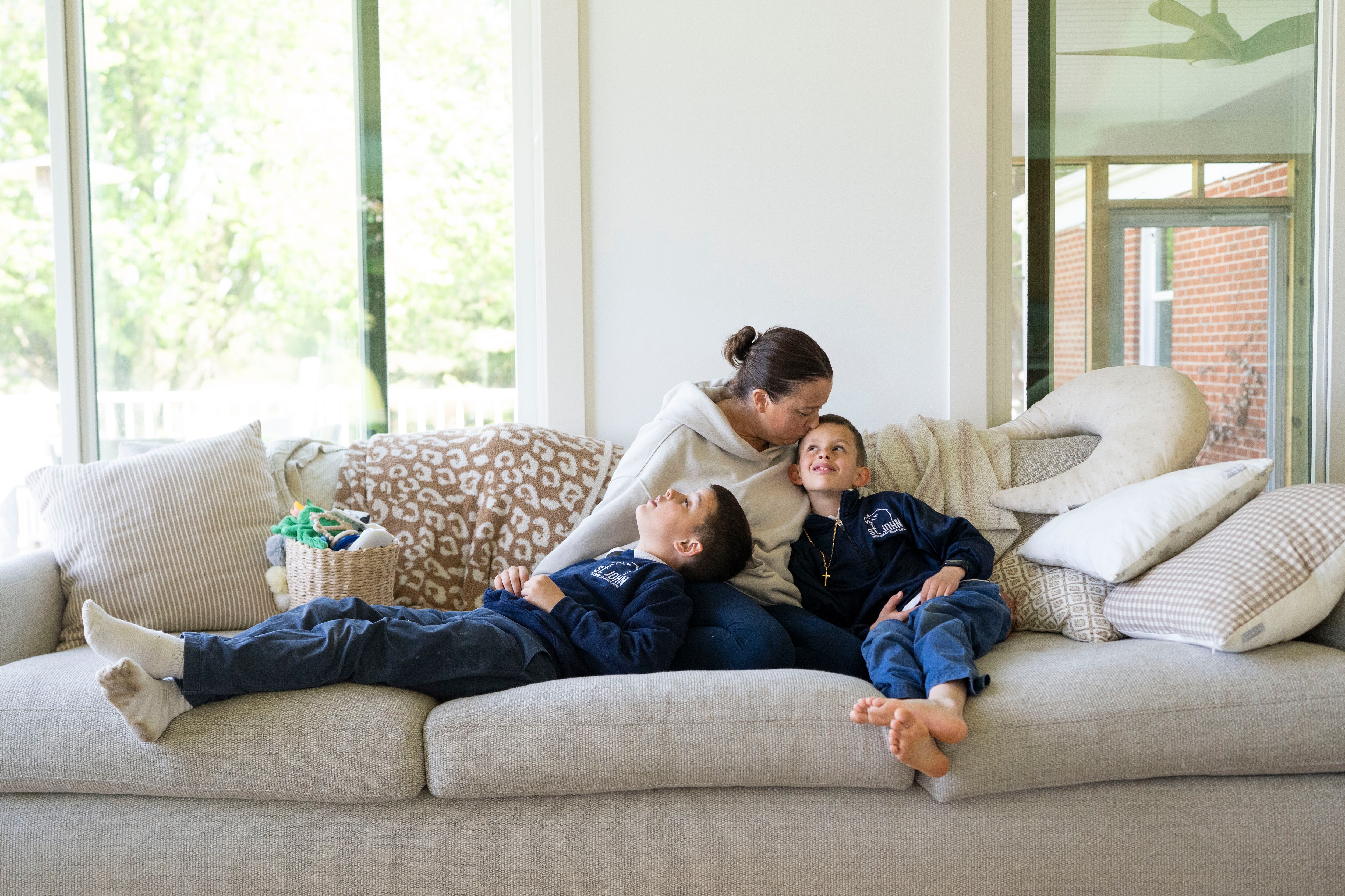 Erin Bull, center, sits with her sons, Carson, left, and Avery, at a family member’s home in Baldwin.
