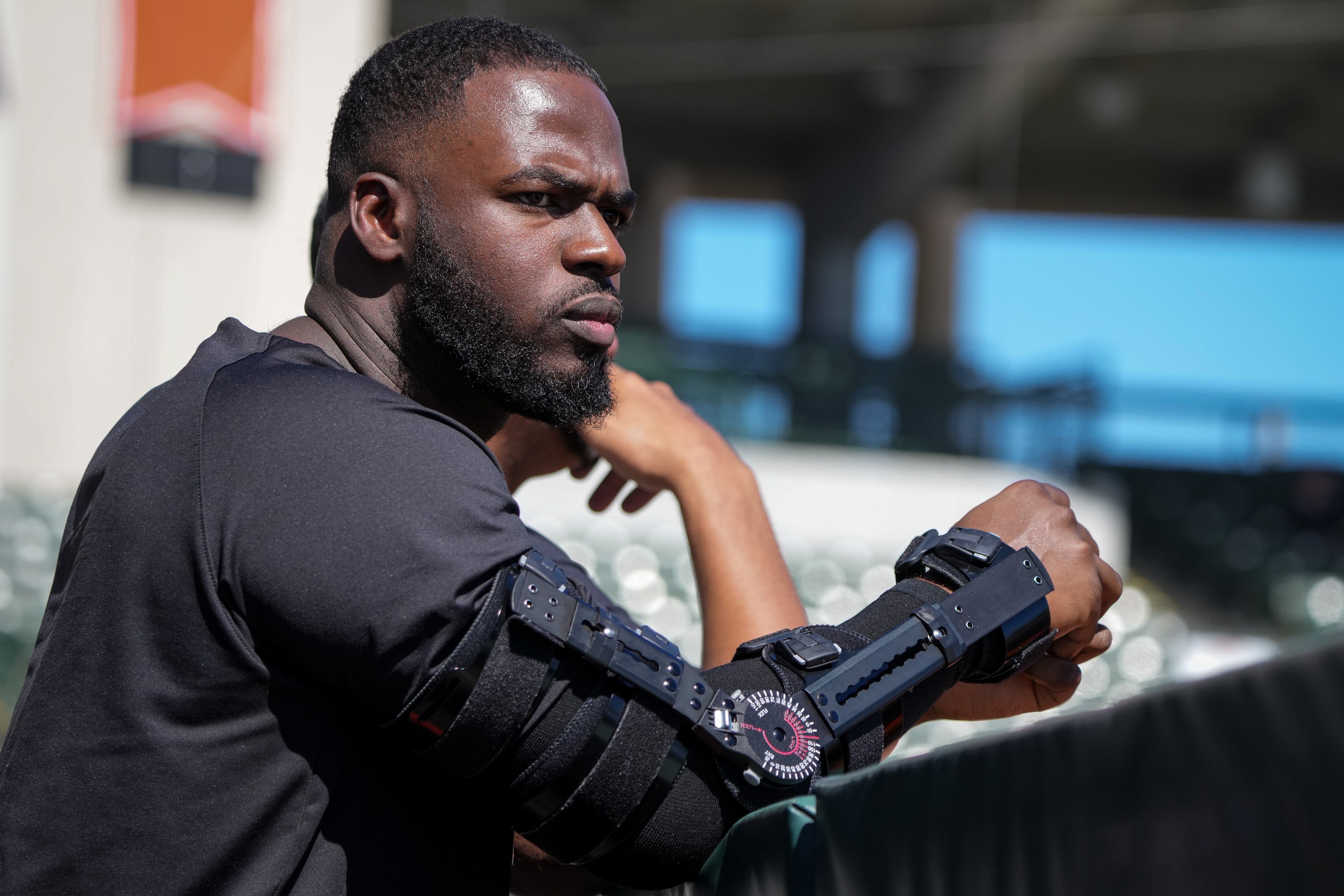 Orioles relief pitcher Félix Bautista wears an arm brace as he watches batting practice.