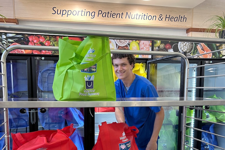 A Meritus Nutrition Services worker unloads bags of food into refrigerators at the Meritus Food Farmacy in the Robinwood Professional Center in Hagerstown.