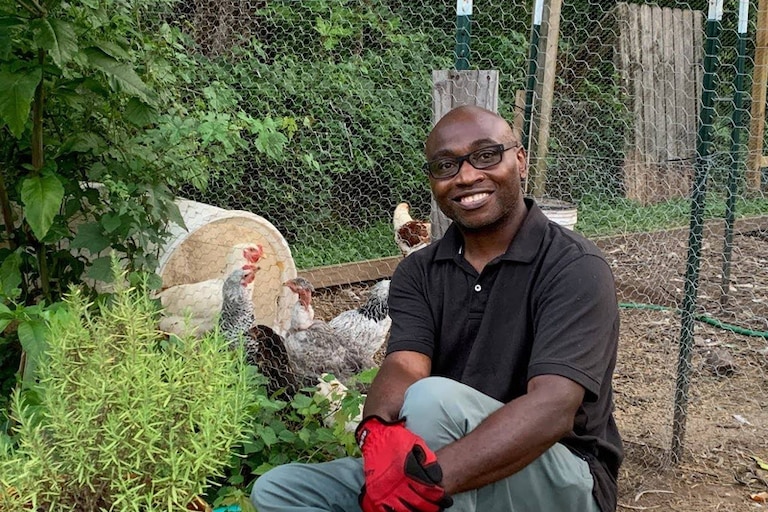 Ulysses Archie, Jr. seen here in his Irvington yard surrounded by his chickens, is a survivor of childhood trauma and a trainer in recognizing such trauma in communities.