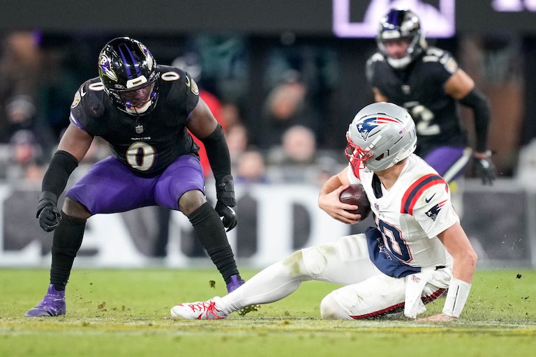 New England Patriots quarterback Drake Maye (10) slides to avoid taking a hit from Baltimore Ravens linebacker Roquan Smith (0) in the fourth quarter of a football game at M&T Bank Stadium in Baltimore, Md. on Sunday, December 21, 2025. The Sunday Night Football game was the Ravens’ final home game of the regular season.