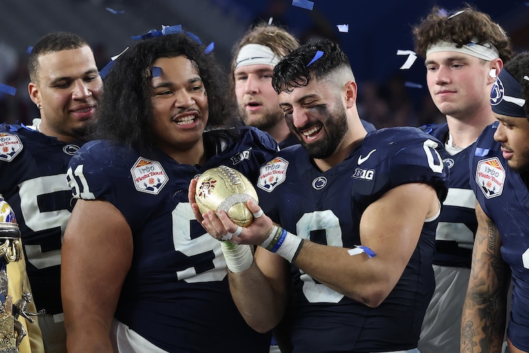 Dominic DeLuca (0) of the Penn State Nittany Lions holds the Fiesta Bowl Trophy following the 2024 Vrbo Fiesta Bowl against the Boise State Broncos at State Farm Stadium on December 31, 2024 in Glendale, Arizona.
