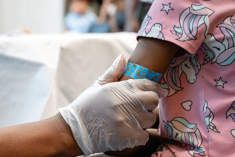 Amina Amusa (8) gets a bandage over the injection site following her vaccines received during a Vaccine Clinic offered at BCPS Fest held at New Town High School on August 16th, 2025 in Owings Mills, MD.