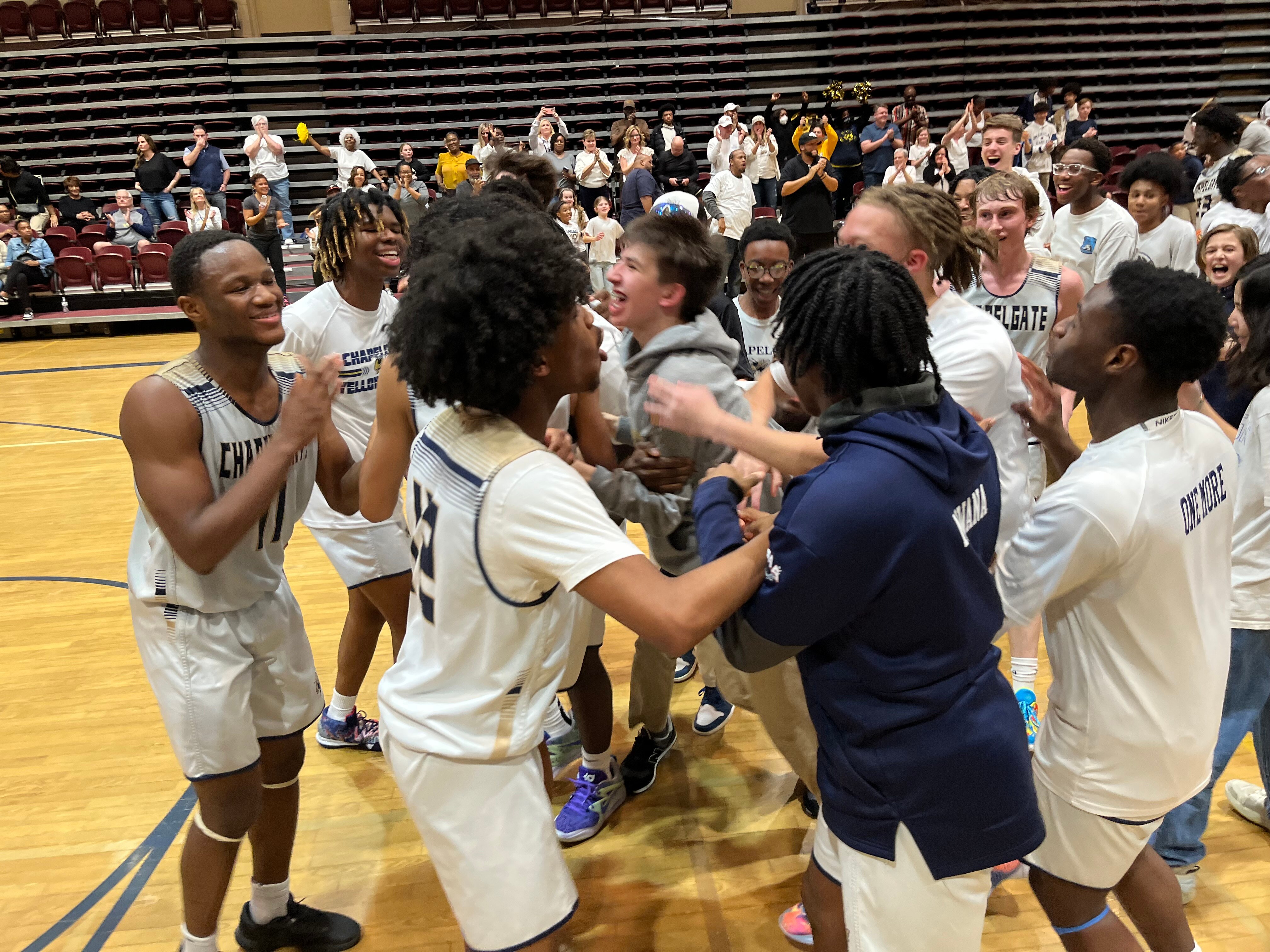 Chapelgate Christian basketball players are mobbed by their fans following Thursday's victory over St. Paul's in the MIAA B Conference boys basketball semifinals. The Yellowjackets advanced to their first championship game since 2011 with a 63-57 victory over the Crusaders in Marriottsville.