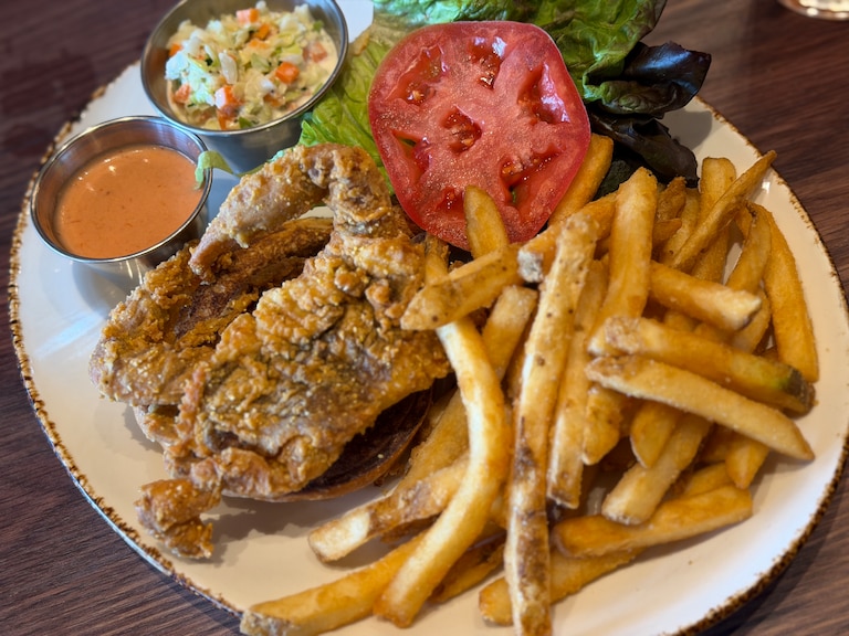 Rye Street Tavern's soft-shell crab sandwich is served on a challah bun, with coleslaw, French fries and cocktail mayonnaise on the side.