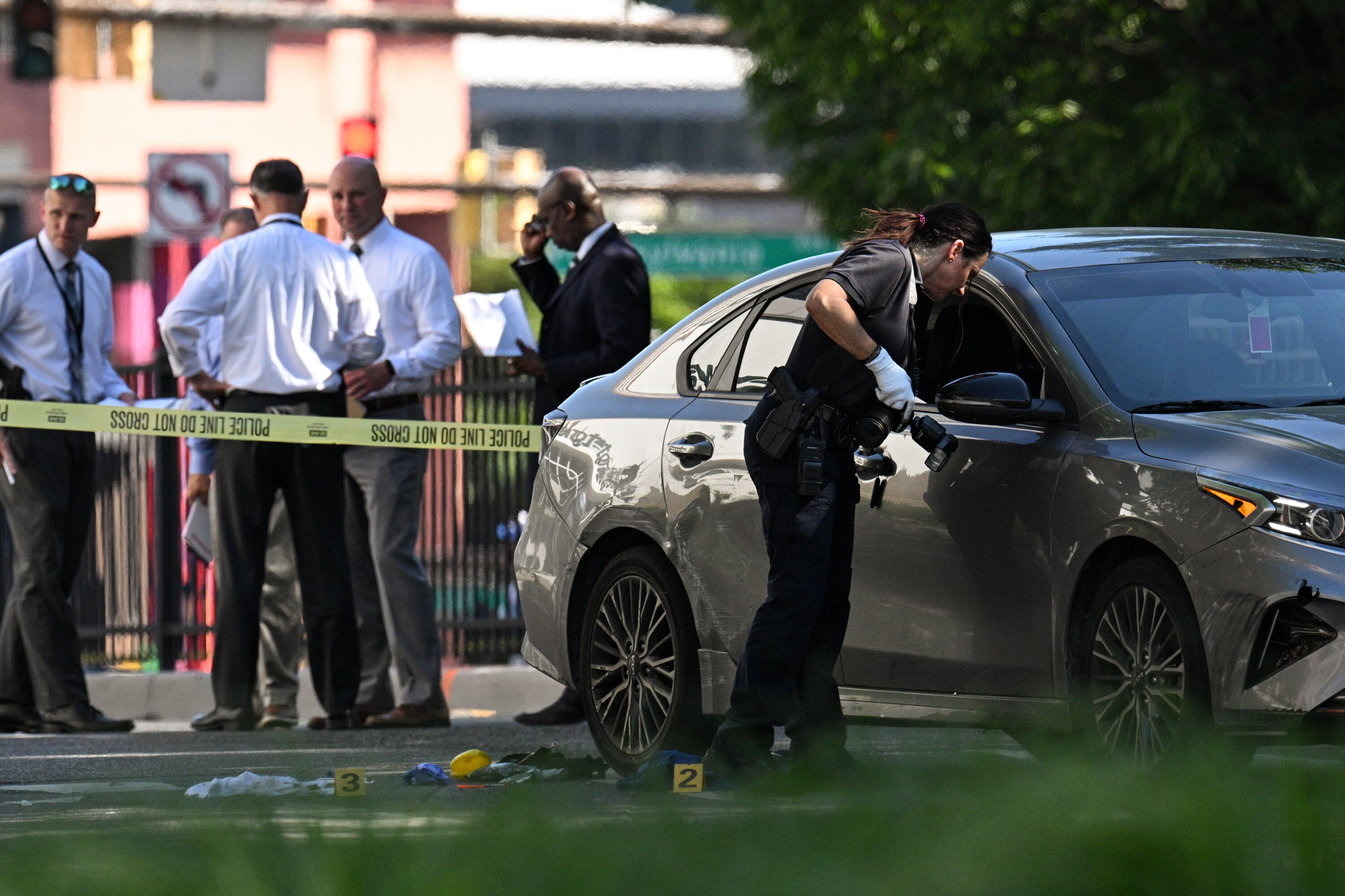 Baltimore County Police officers respond to a reported shooting that occurred along York Road in Towson on Friday afternoon. Bullet holes can be seen in the door of a vehicle.